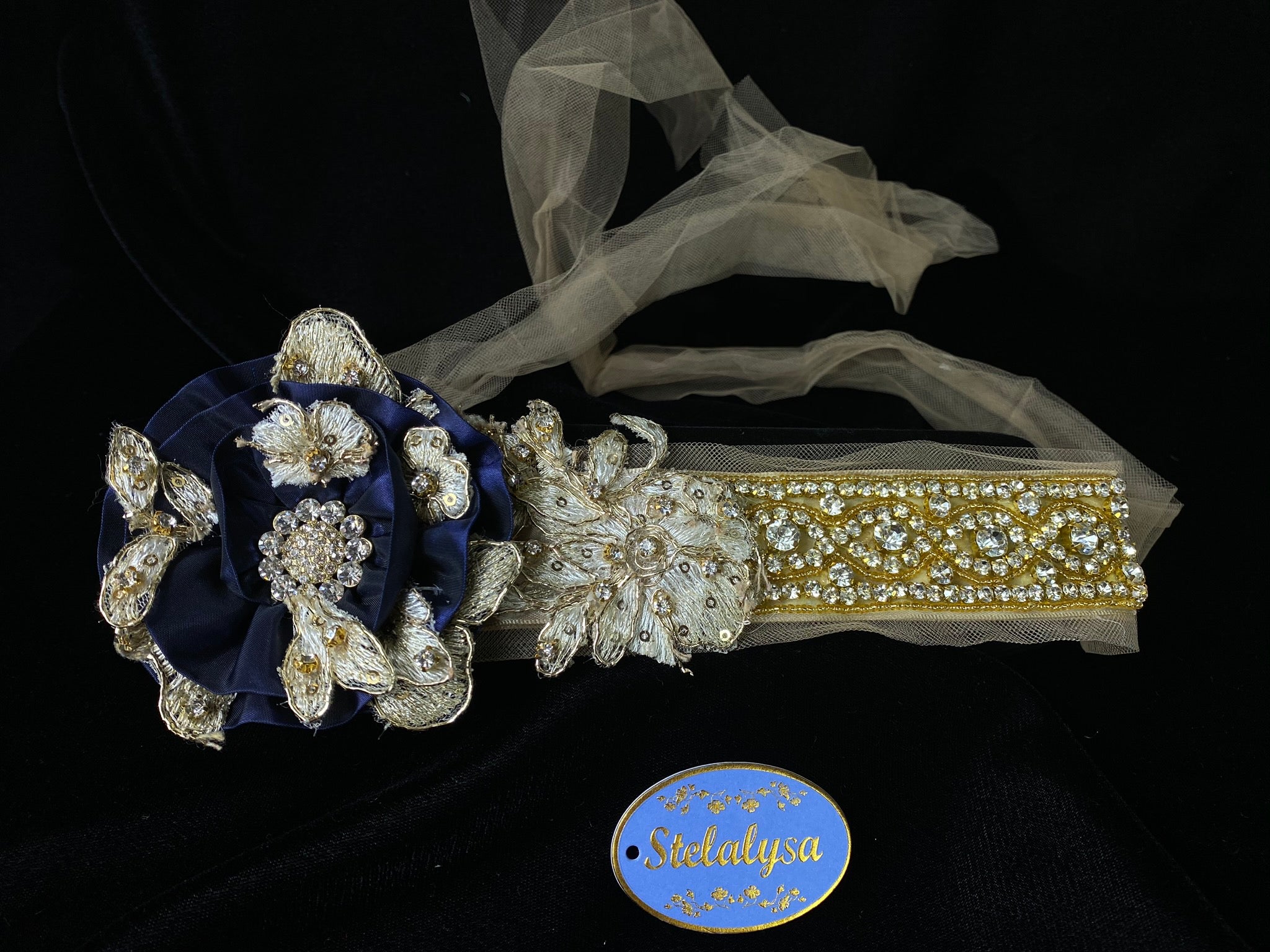 Headband with Strings - Royal Blue Flower and Champagne Tulle Strings  This is an elegant unique handmade and one-of-a-kind headband with a large Royal Blue flower and Champaign and Gold headband and long tulle strings attached.  The large flower is uniquely decorated with rhinestones, beads, and hand stitched flowers. The soft headband is made with elegant flowers with sequins, gold sequins, and rhinestones.  
