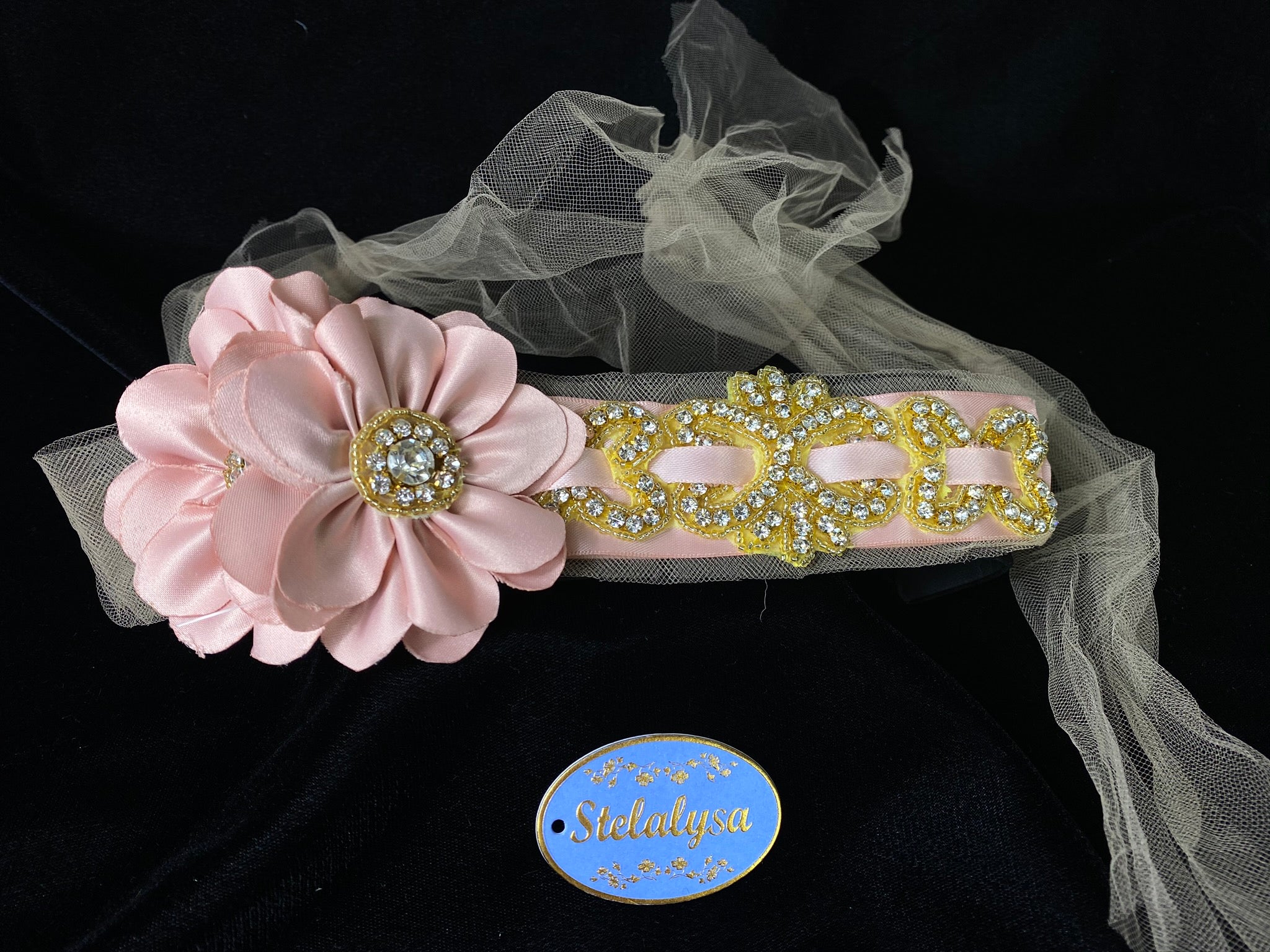 Headband with Strings - Pink Flower with Champagne Tulle Strings  This is an elegant unique handmade and one-of-a-kind headband with a large Pink flowers and long Pink tulle strings attached.  The large flower is uniquely decorated with rhinestones and gold beads.  The headband is made of soft pink satin and gold sequins and rhinestones. 