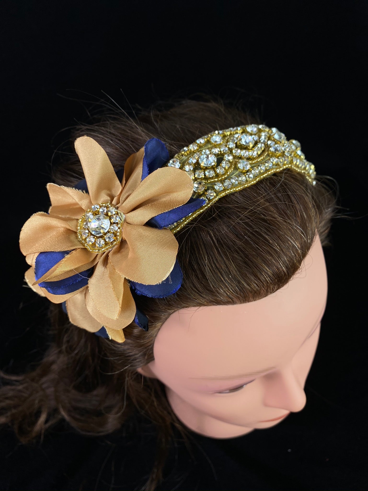 Navy & Gold Rhinestone Headband  This is an elegant handmade and one-of-a-kind headband with a large satin navy and gold flower with gold beads and rhinestones.  The headband is made of an intricate rhinestone and bead design.  This headband can be worn with dresses from Stelalysa's Celebration/Pageant Collection and for any occasion!  It fits best on girls ages 1-6.