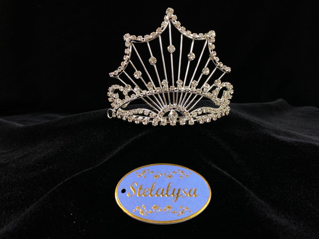 A must have for the First Communion!   Beautiful tiara, covered in gorgeous rhinestones creating web detailing.  Tiara is 4" wide with a 1.5" comb.  Tiara goes about 2/3 of the way around the head.   Wear this tiara with either a white or ivory veil from our Veil Collection to complete the look for the ceremony.