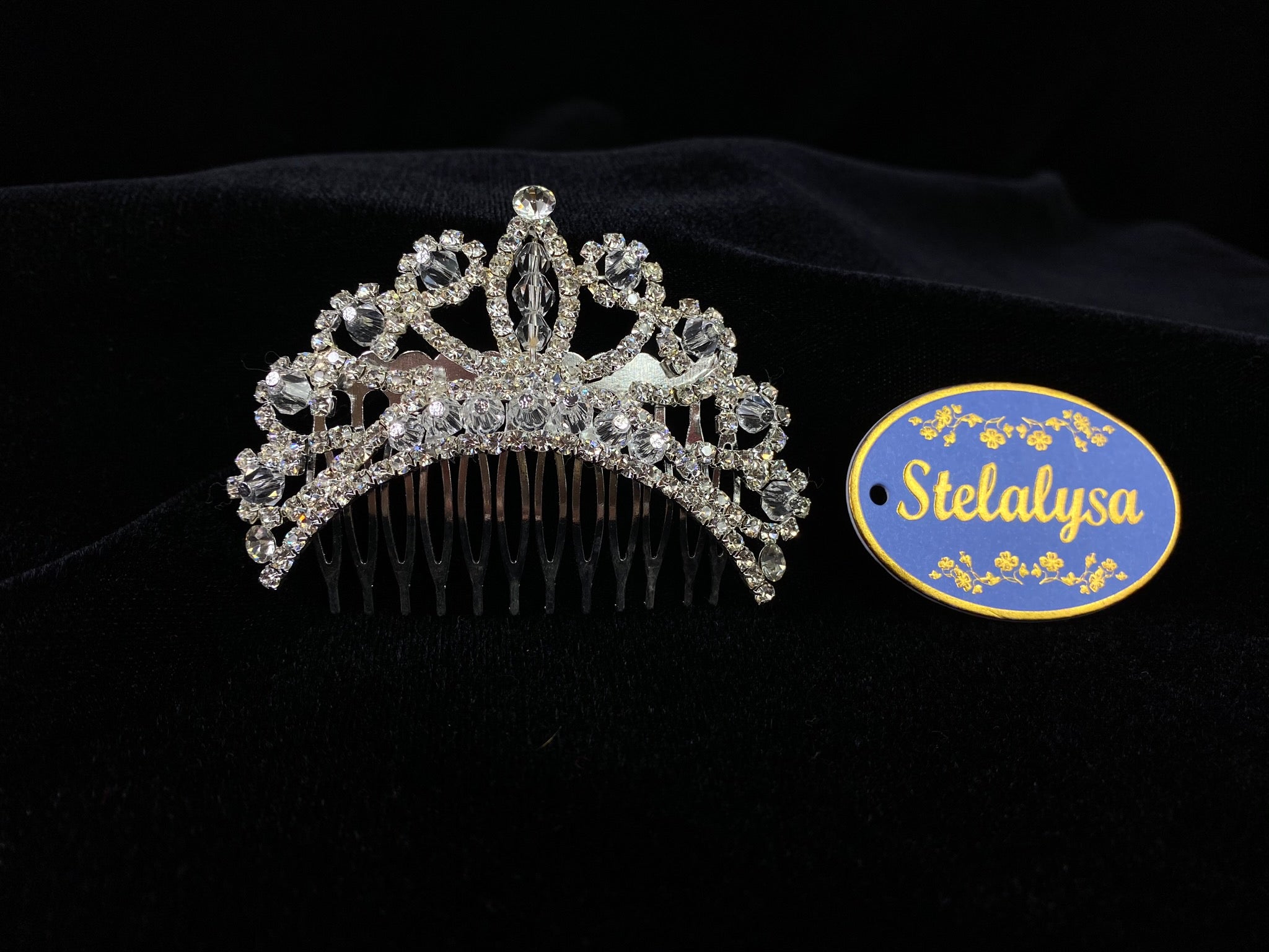 A must have for the First Communion!   Beautiful tiara, covered in gorgeous rhinestones with crystal detailing.  Tiara is 3" across.  Wear this tiara with either a white or ivory veil from our Veil Collection to complete the look for the ceremony.