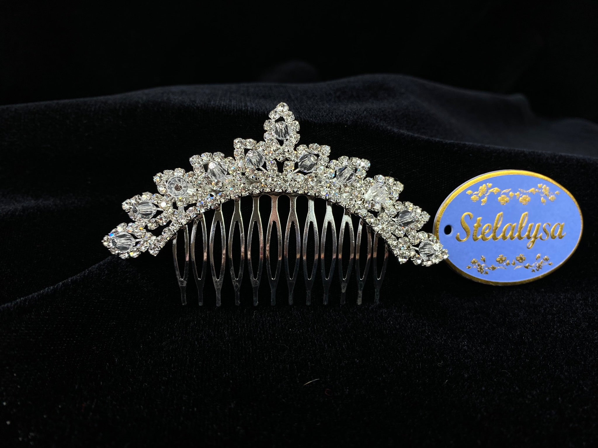 A must have for the First Communion!   Beautiful tiara, covered in gorgeous rhinestones with crystal detailing.  Tiara is 4" across.  Wear this tiara with either a white or ivory veil from our Veil Collection to complete the look for the ceremony.