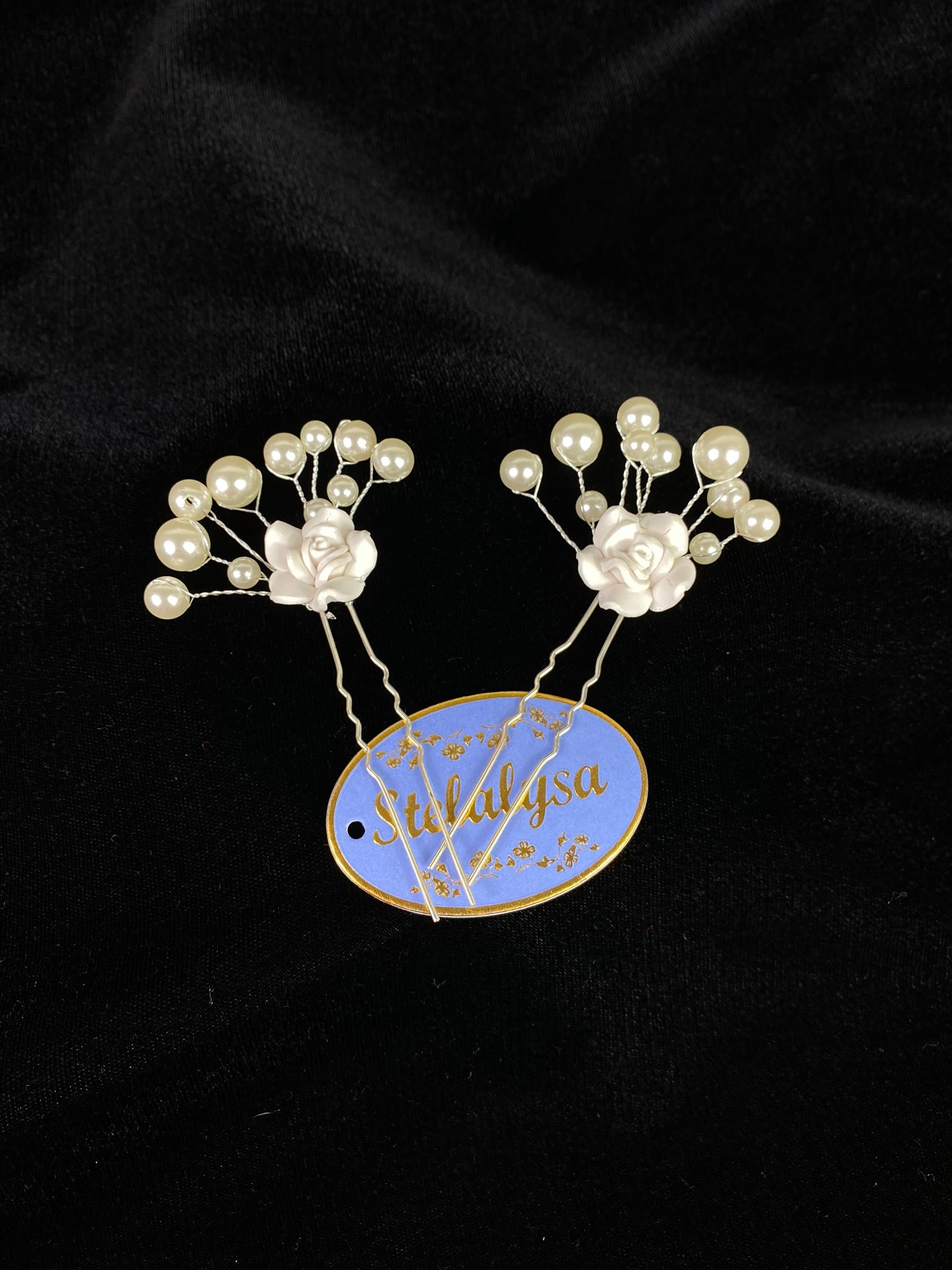 Decorative hair pin with pearls and single rose.  Comes as a set of 2.