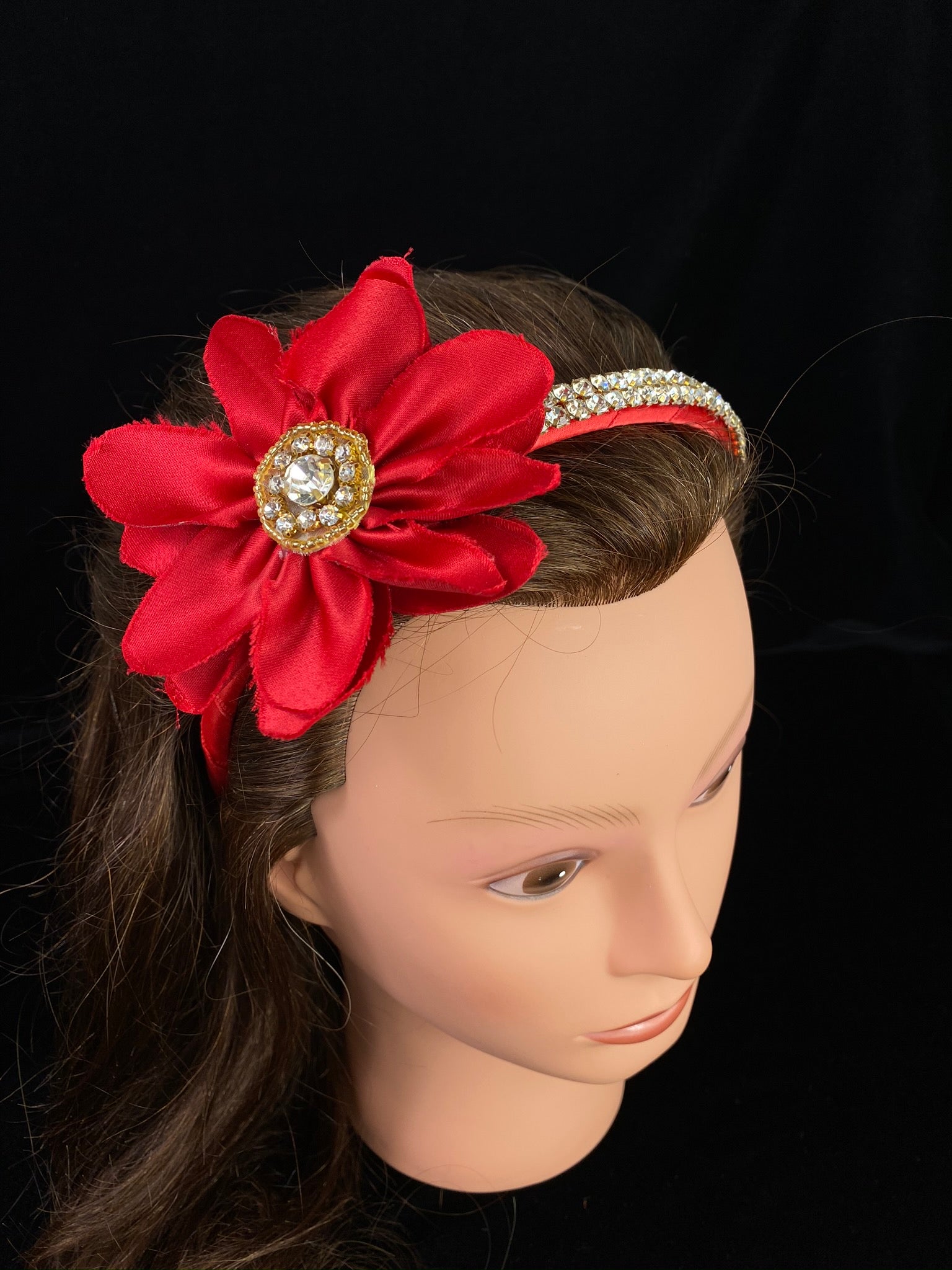 Red Rhinestone Headband with Flower  This is a one of a kind, hand made large red headband.  The beautiful red satin headband is striped with rhinestones.  This headband can be use with dresses from the Celebration / Pageant Collection.    This headband fits on little girls ages 1-8.