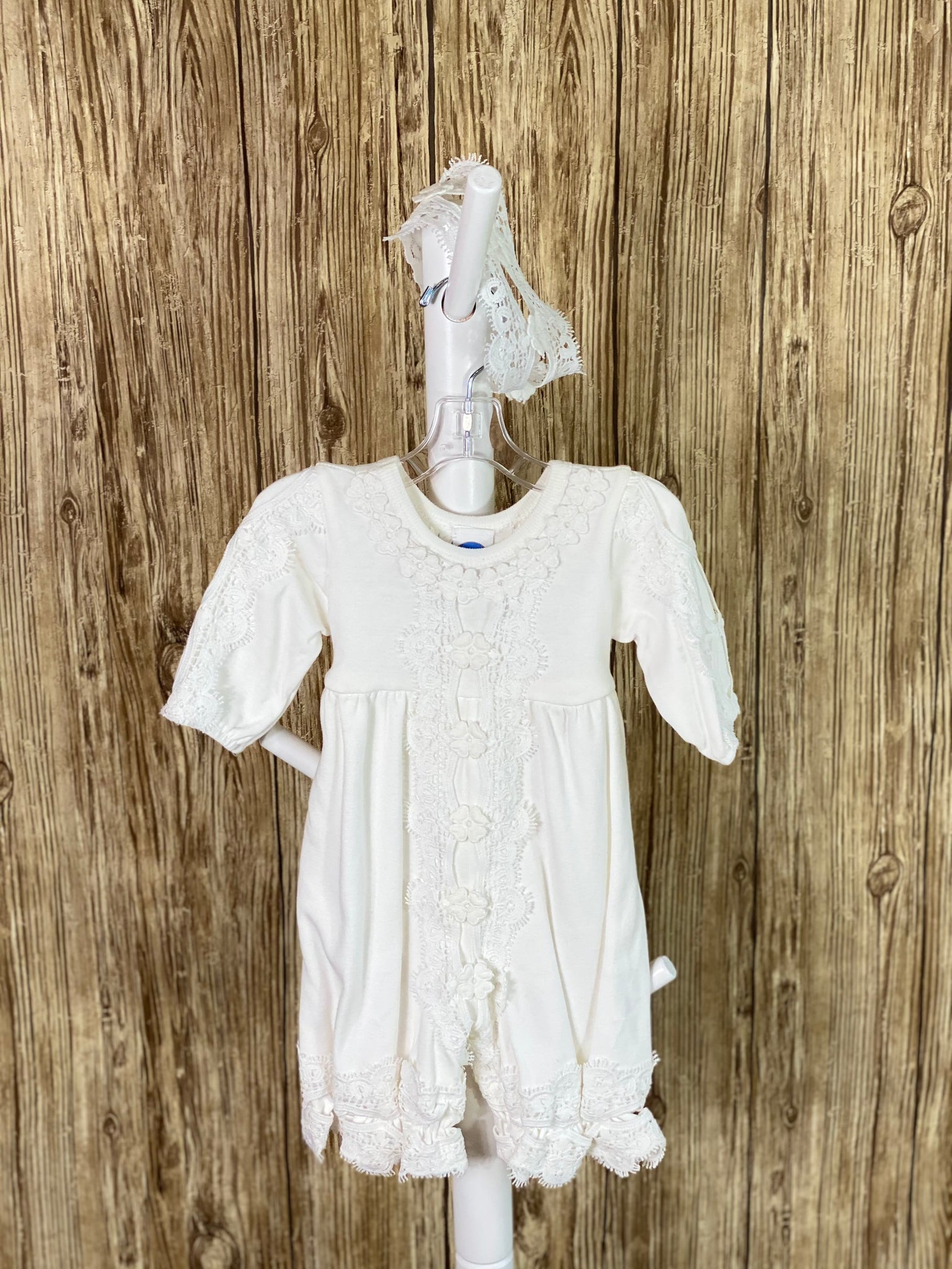 Cotton baby romper  Flower lace around neckline Flowered lace down center of romper and arms Lace around leg holes Lace headband
