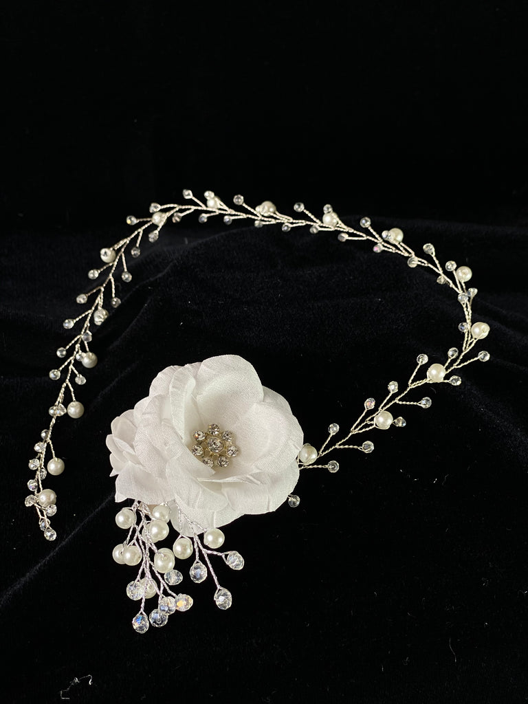 A must have for the First Communion!   Beautiful headband applique with pearl and rhinestone banding.  Organza flowers with rhinestone centers placed on side of band.   Headband is 22" long, to sit beautifully around the head.   This headband will adorn a Stelalysa veil!  Wear with either a white or ivory First Communion dress!