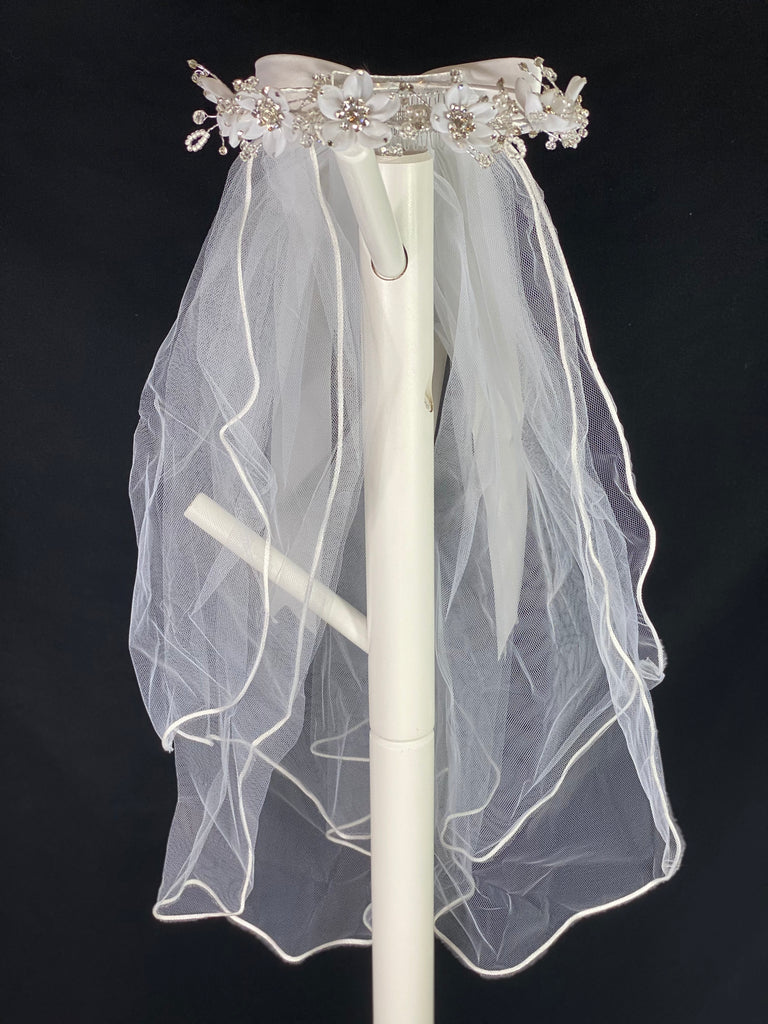 Elegant soft 2 layer tulle veil with delicate hand stitched braided satin trim around the edge and handmade flower halo crown with veil with large white satin bow on back. Organza flowers with sparkling rhinestone petals and centers. Beautiful clear beaded and pearl leaves sticking out around flowers.  This double layered veil reaches approximately 24" long, with a crown diameter of 6". Veil has 2" long, 3" wide, comb to secure it in place. 