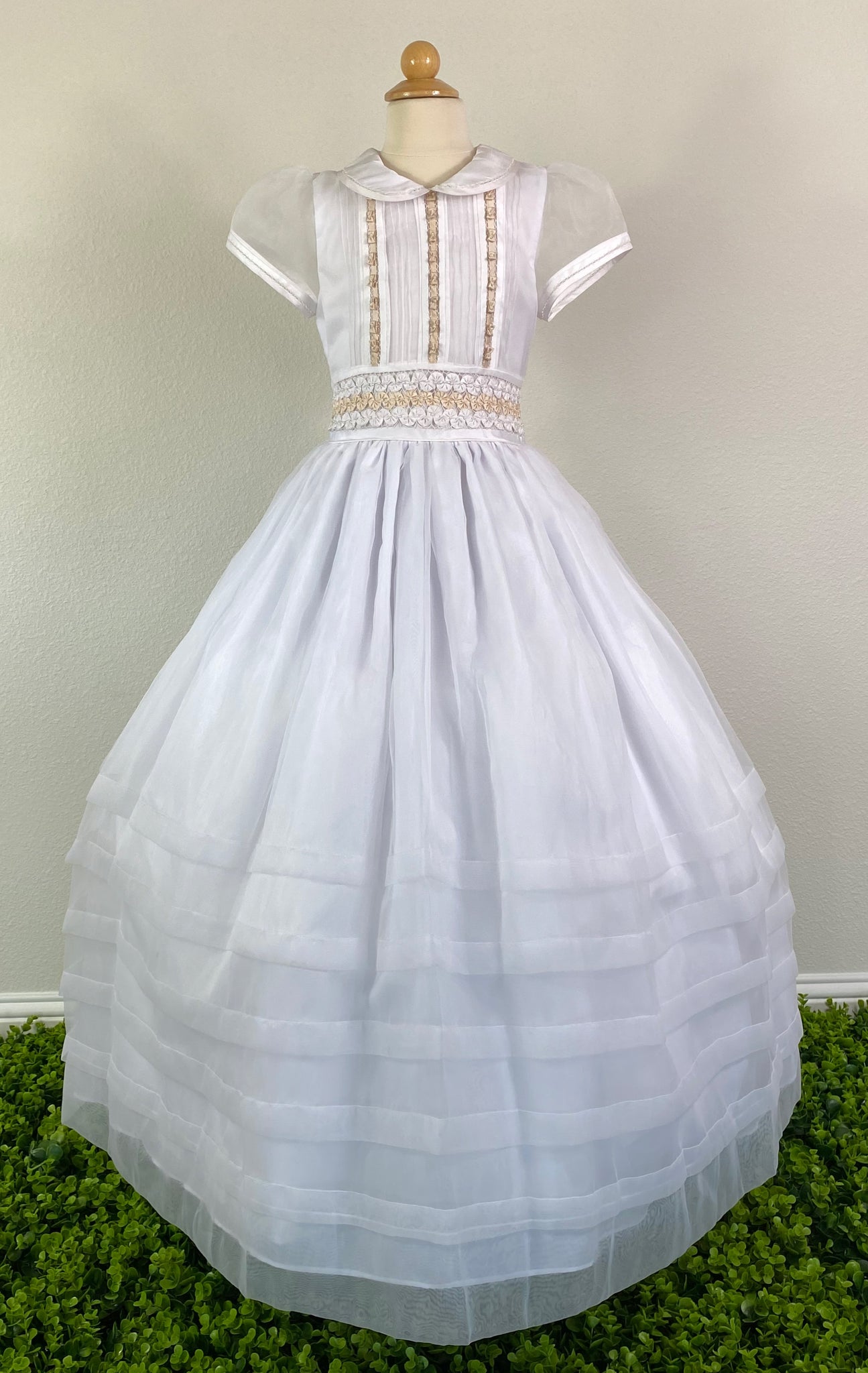 White, size 10 Contrast collar Satin trimmed short sleeve Vertical pleats with beige bows on front bodice with pearls Wide Band with three rows of pinwheel bows (white, beige, white) Stripe bands around bottom Pearl button closure Mesh ribbon for bow