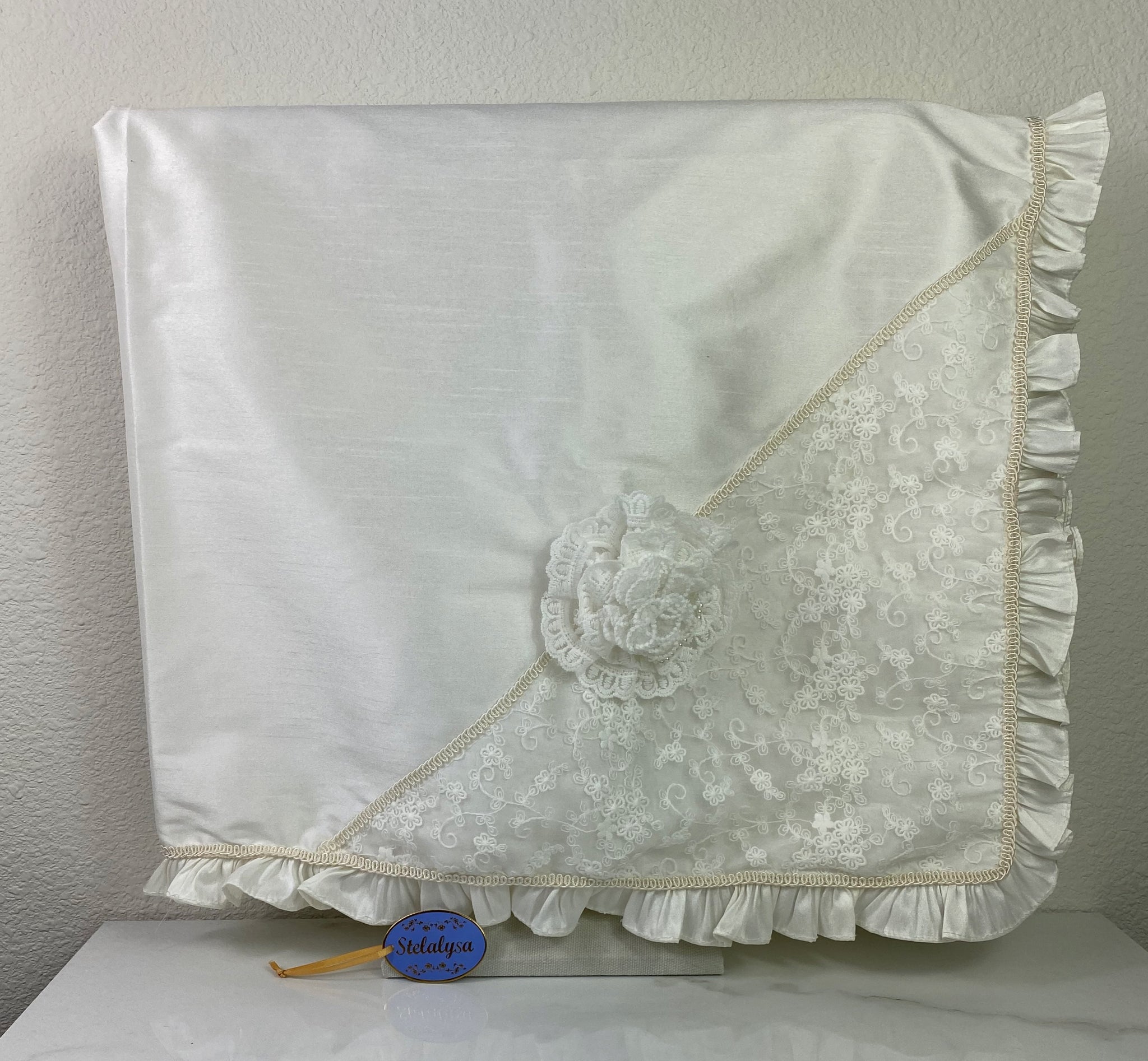 Beautiful ivory silk baptism blanket with a lovely lace overlay and flower.