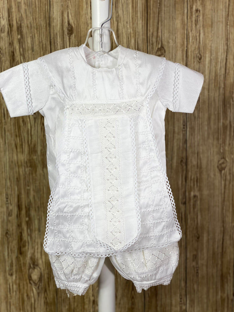White, size 6M  4-piece set including shirt, pants, one piece stole, beret Tassel pin with 3 rhinestone centered circles Intricate trim grid on stole with diamond design on flap Pearl and crystal detailing on flap Collared shirt with short sleeves Satin cuffs and cummerbund outlined with intricate braided trim Intricate braided trim around beret Swirled trim design on pant legs and shirt bodice Buttoning on pant cuffs Elastic banding behind pants Button closure on back of shirt