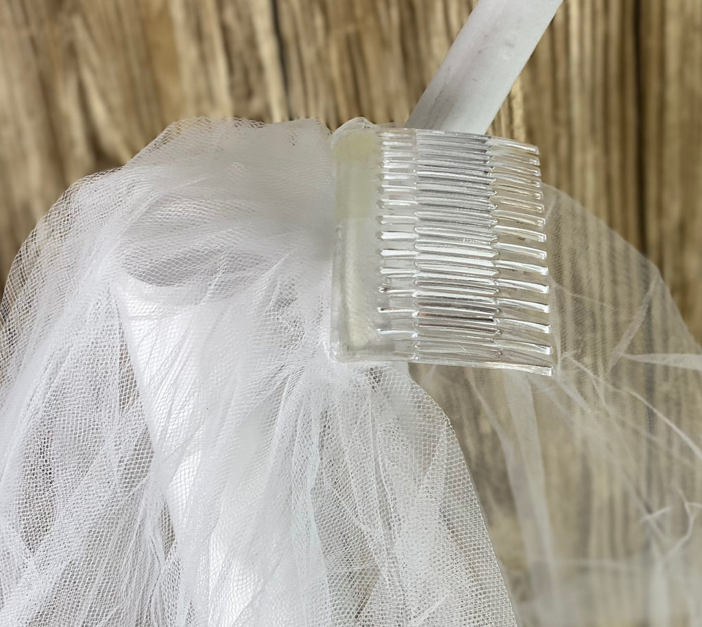 White - Floating Pearl Veil for First Communion   Elegant soft 2 layer veil with white pencil trim and delicate floating pearls.   Veil length - 30 in. long, comb - 7 cm wide  Materials:  sturdy plastic comb, soft tulle, and applique - pearls.