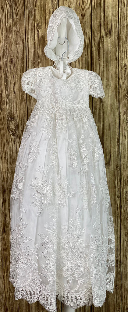 This a beautiful, one-of-a-kind baptism gown.  A lovely gown for a precious child.  Satin bodice with beautiful lace overlay Short laced sleeves Large satin skirting with lace overlay Scalloped lace edging Gorgeous lace bonnet Satin ribbon closure Available in two colors white & ivory