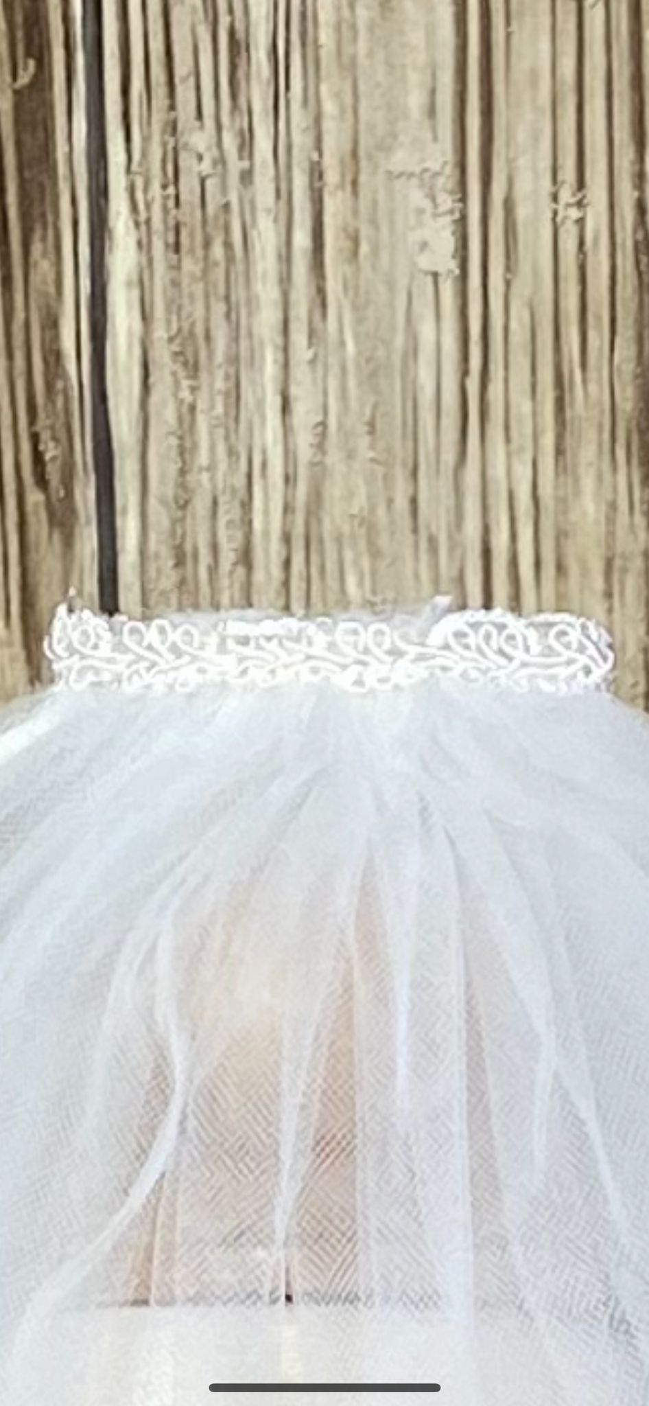  Ivory - Classic Veil for First Communion   Elegant soft 2 layer tulle veil with delicate hand stitched braided satin trim around the edge.  Veil length - 22 in. long  Handmade halo ivory lace crown with comb (2 in. wide to secure in place).  Materials:  sturdy plastic comb and soft tulle.