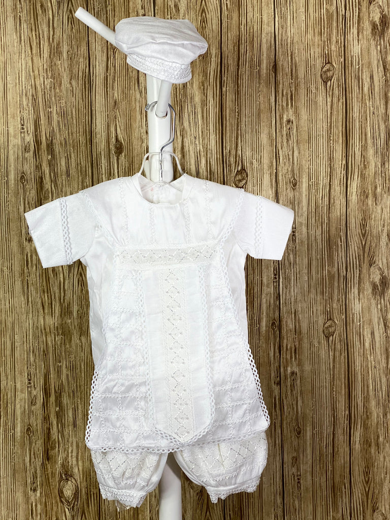White, size 6M  4-piece set including shirt, pants, one piece stole, beret Tassel pin with 3 rhinestone centered circles Intricate trim grid on stole with diamond design on flap Pearl and crystal detailing on flap Collared shirt with short sleeves Satin cuffs and cummerbund outlined with intricate braided trim Intricate braided trim around beret Swirled trim design on pant legs and shirt bodice Buttoning on pant cuffs Elastic banding behind pants Button closure on back of shirt