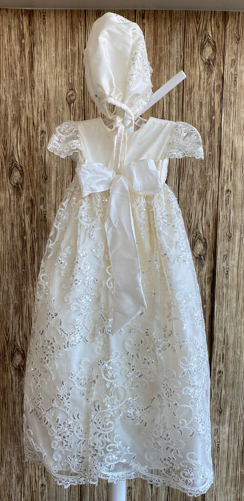 his a beautiful, one-of-a-kind baptism gown.  A lovely gown for a precious child.  Ivory, size 6M  Satin bodice with sequins embroidered lace overlay Sequins embroidered lace cap sleeve Pleated sequins embroidered lace skirting Satin bonnet with sequins embroidered lace overlay Tulle ruffled brim on bonnet