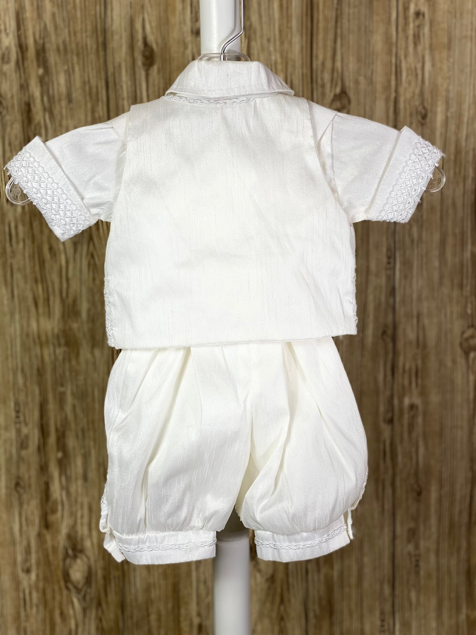 This a beautiful, one-of-a-kind boy’s baptism gown/set.  Lovely clothes for a precious child.  White, size 6M  5-piece set including shirt, pants, vest, bow tie and beret Pearl closure on vest Braided trim on vest collar edging, pant cuffs and cummerbund, and beret band Pearl button down shirt with crochet ribbon down sides Ribbon around arm cuffs and pant legs Buttoning on pant cuffs Elastic banding behind pants