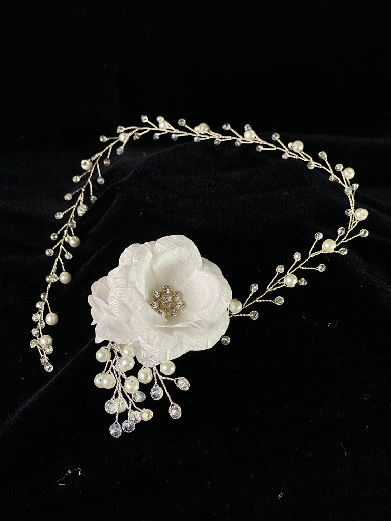 A must have for the First Communion!   Beautiful headband applique with pearl and rhinestone banding.  Organza flowers with rhinestone centers placed on side of band.   Headband is 22" long, to sit beautifully around the head.   This headband will adorn a Stelalysa veil!  Wear with either a white or ivory First Communion dress!