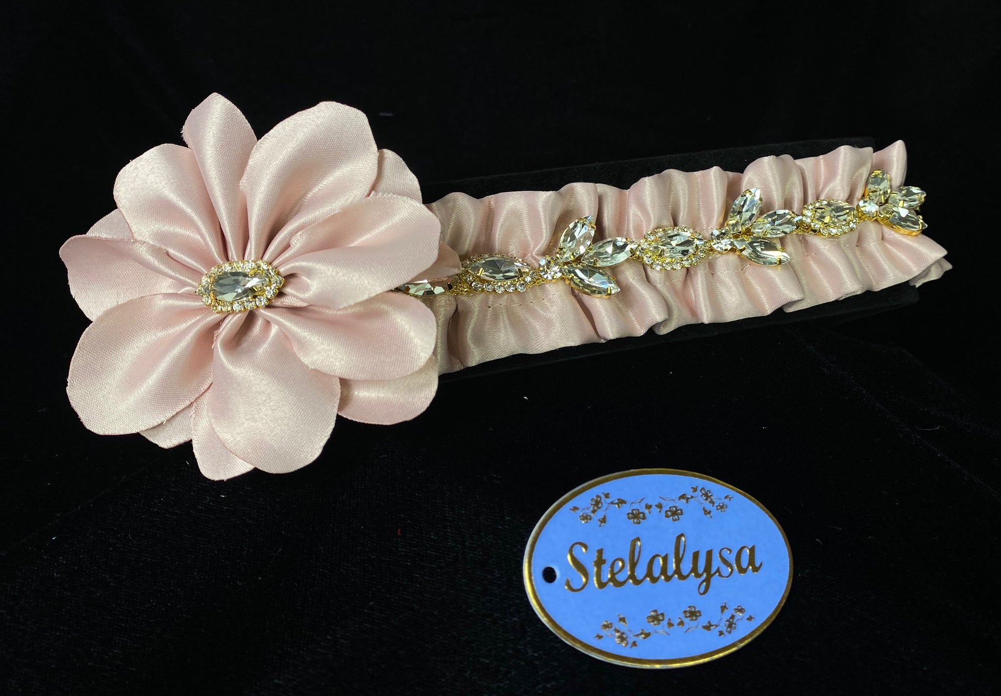 Headwrap - Pink Flower with Large Rhinestones  This is an very elegant handmade and one-of-a-kind Pink headwrap with a large satin flower with rhinestones.  The elastic headwrap is made of a soft satin with large rhinestones.  This headwrap can be worn with dresses from Stelalysa's Celebration/Pageant Collection and for any occasion!  It fits best on ages 1-6.