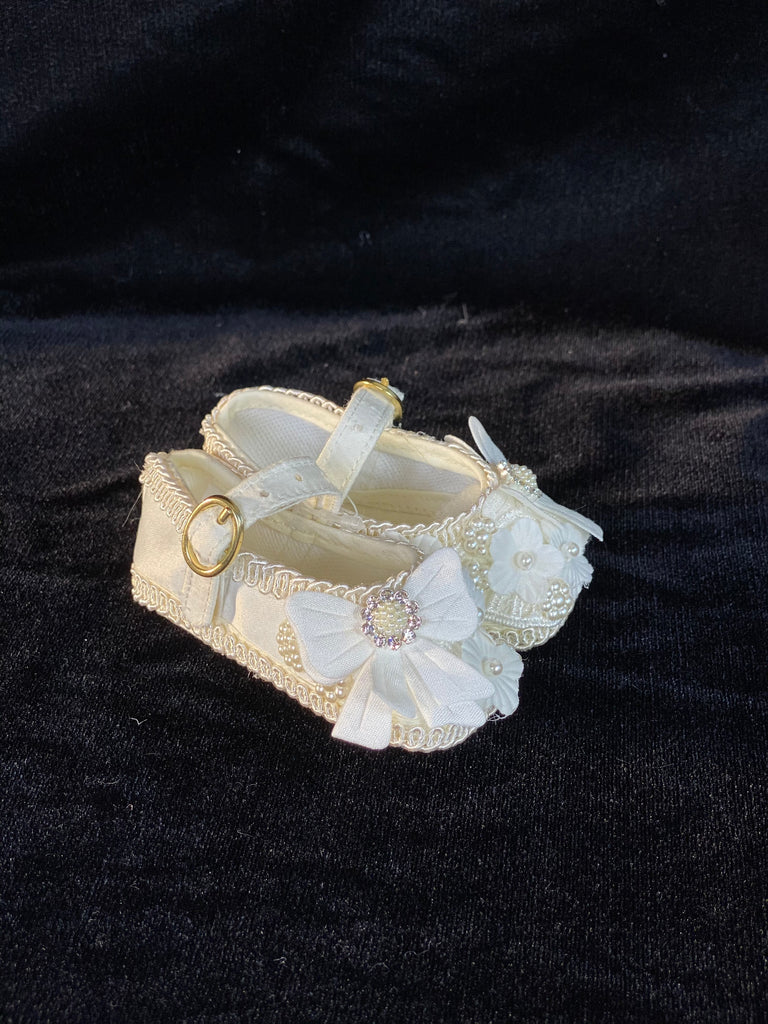 Elegant handmade ivory and white baby girl shoes with embroidery, lace, flowers, bows, and jewels (pearls and crystals).
