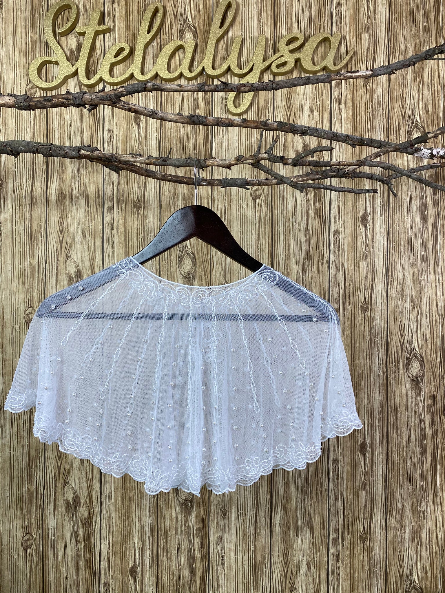First Communion - Shawl with Pearls  Stunning white tulle shawl with embroidered swirl and pinstriping pearls.  This shawl can be worn with either a white or ivory communion dress/gown from our collection.  She will look like a princess wearing this elegant shawl on her special day!  