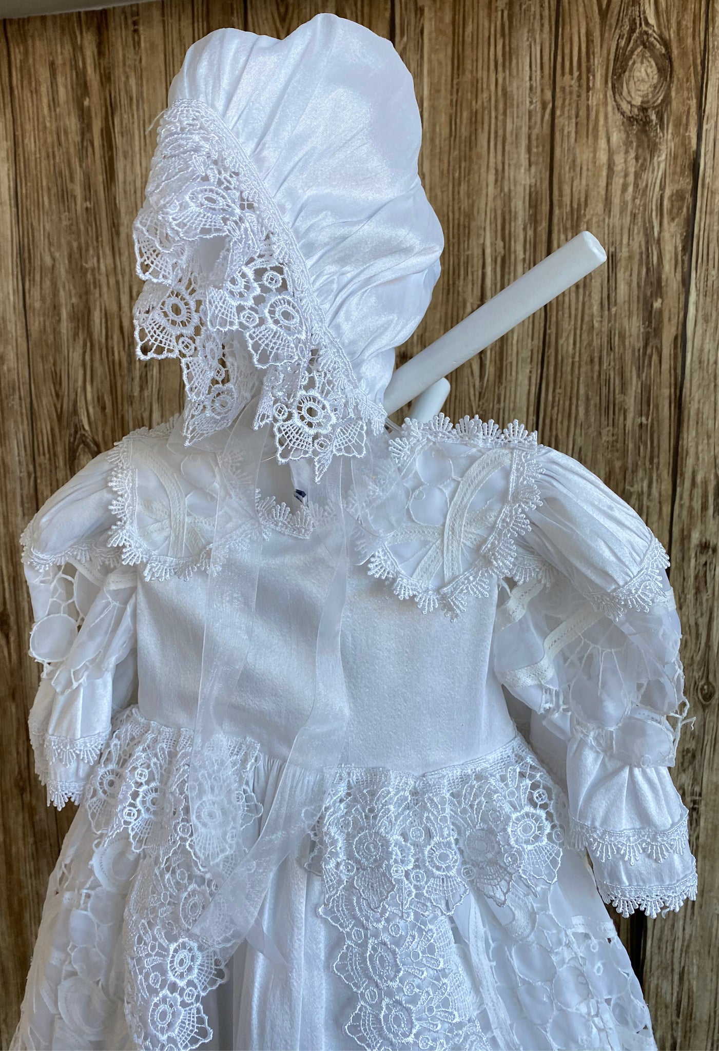 This a beautiful, one-of-a-kind baptism gown.  A lovely gown for a precious child.  White, size 12M Satin bodice with lace collar Beautiful lace trim edging collar and sleeves Satin puff sleeve with lace patch  Satin skirting with lace overlay  Thick embroidered lace ribboning around overlay and skirt edge Lovely satin bonnet with thick embroidered lace brim Mesh ribbon closure on bonnet
