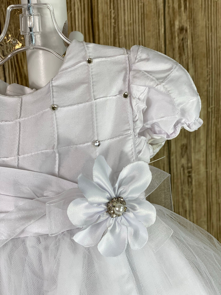 This a beautiful, one-of-a-kind baptism gown.  A lovely gown for a precious child.  White, size 12M Cubed satin bodice with rhinestones Satin cubed sleeves Satin belt with flower Tulle skirting with satin underlay Satin bow in back Button closure