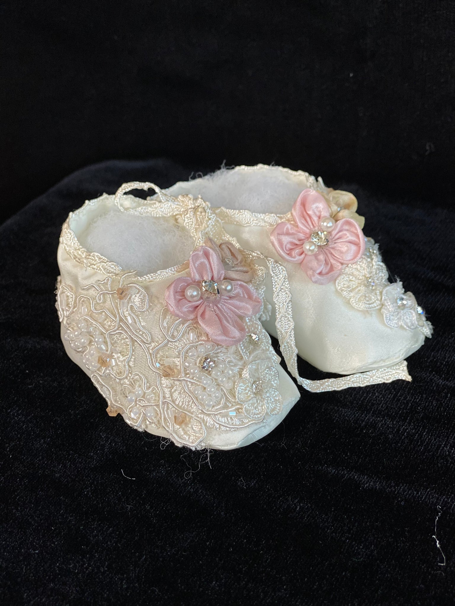 Elegant handmade ivory / white baby girl ankle boots with embroidery, lace, flowers, and jewels (pearls and crystals) with side string closure.