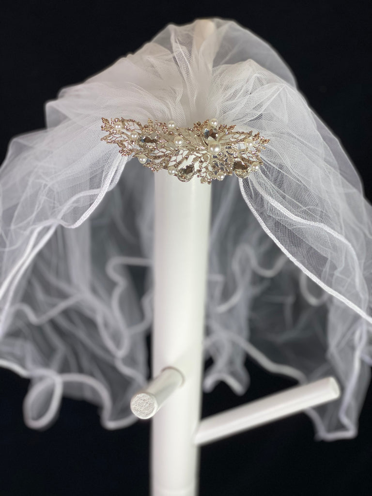 White Elegant Decorative Comb Tiara with pearls and rhinestones.  Elegant soft 2 layer tulle veil with delicate hand stitched braided satin trim around the edge and handmade decorative comb with pearl and rhinestone detailing.  This double layered veil reaches approximately 21" long. Veil has 1.5" long, 2" wide, metal comb tiara to secure it in place. 