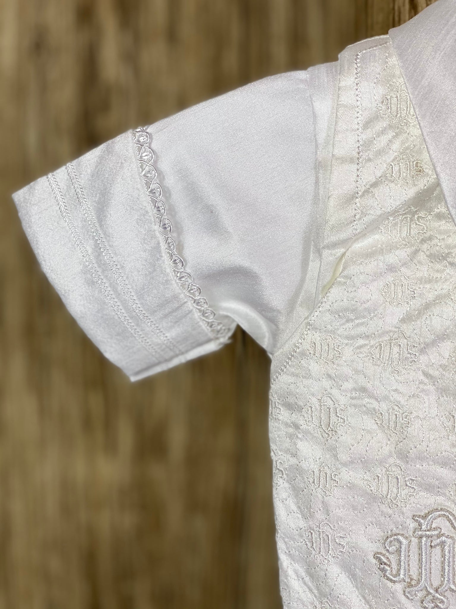 This a beautiful, one-of-a-kind boy’s baptism gown/set.  Lovely clothes for a precious child.   WHITE   4-piece white set including beret, vest, shirt, suspender pants JHS symbol embroidered into vest (JHS stands for Jesus Holmium Salvatore, Latin for Jesus Savior of Mankind) Tassel pin with 3 rhinestone centered circles Thin trim along cuffs, beret, and up pant legs Collared shirt with short sleeves Buttoning on pant cuffs Elastic banding behind pants Button closure on back of shirt