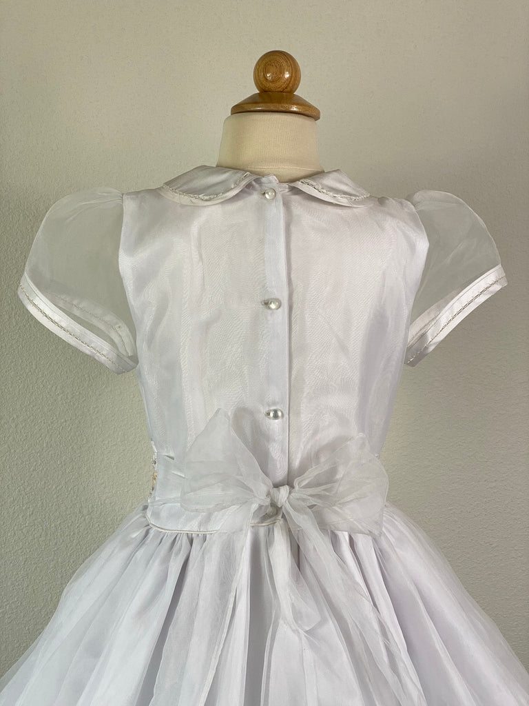 White, size 10 Contrast collar Satin trimmed short sleeve Vertical pleats with beige bows on front bodice with pearls Wide Band with three rows of pinwheel bows (white, beige, white) Stripe bands around bottom Pearl button closure Mesh ribbon for bow