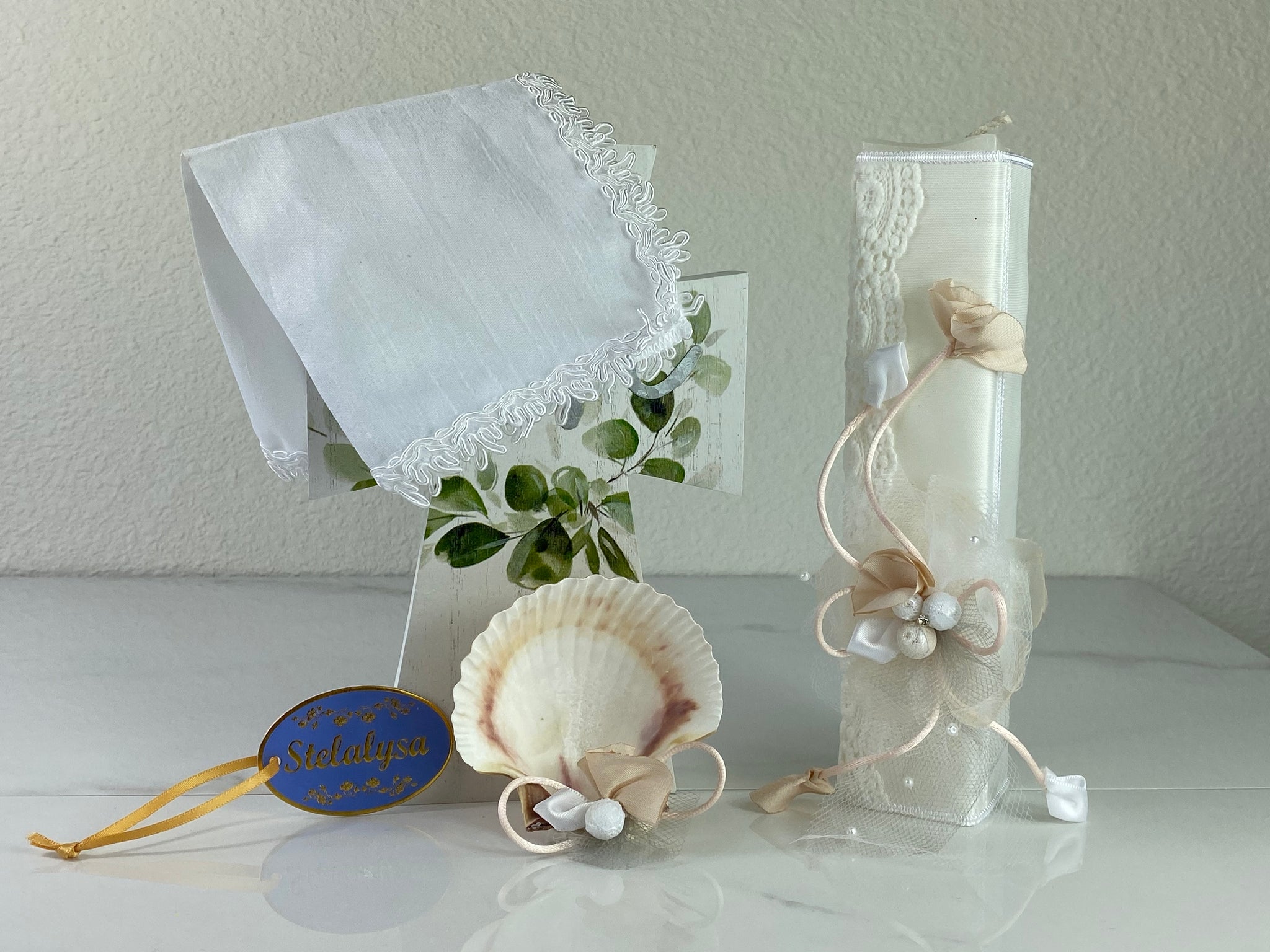 These one-of-a-kind Candle set is handmade and ivory in color.  This candle has an elegant look.   It is uniquely decorated with crystals, lace, tulle, and ribbons making it a gorgeous keepsake.   This candle is rectangle in shape.    To match, the Shell is put together piece by piece to compliment the Candle and Handkerchief.  The Handkerchief is made of satin and embroidered lace to match the Shell and Candle beautifully.  