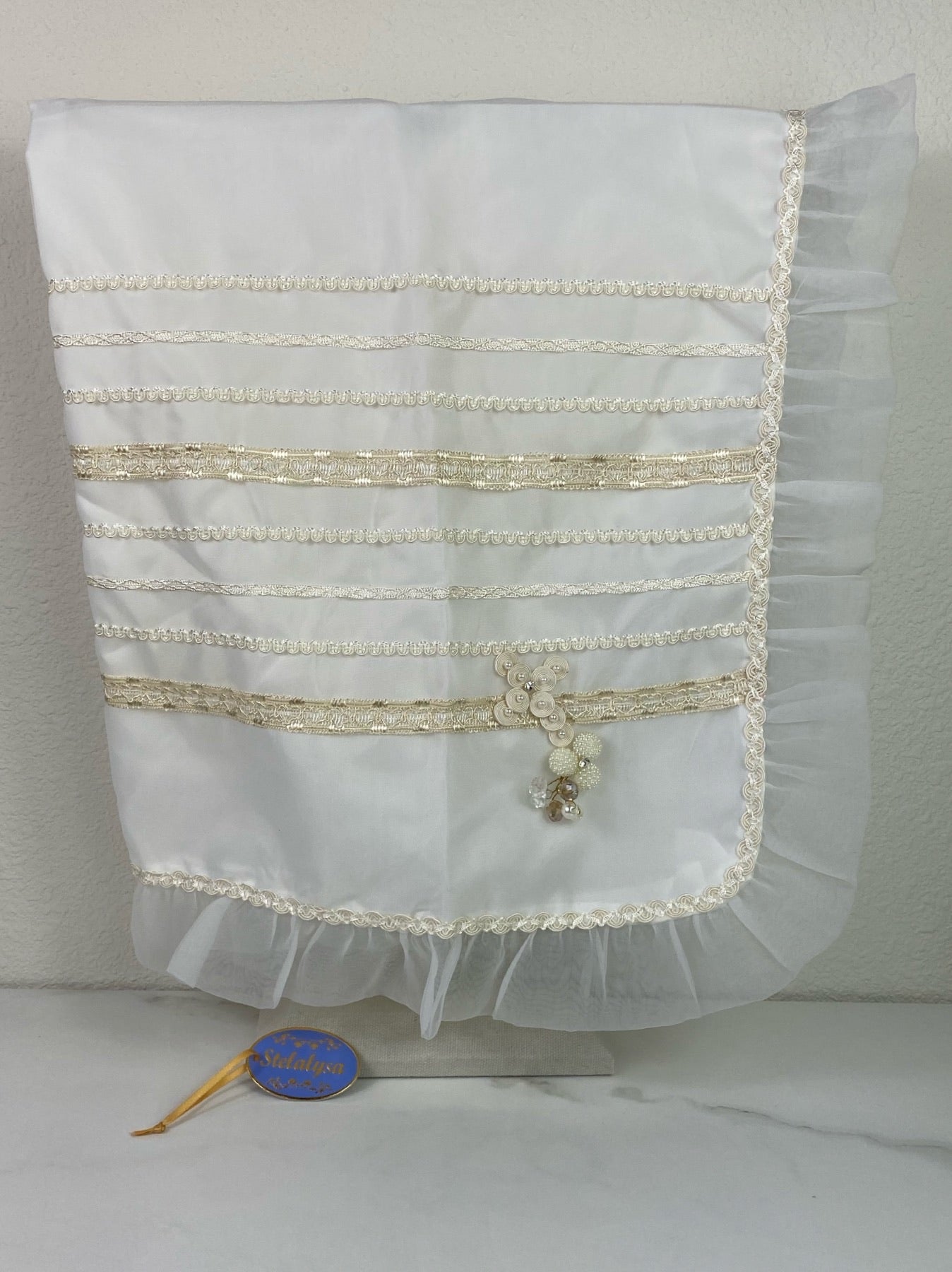 Beautiful ivory tulle silk baptism blanket with cross, ruffled edge, and jewels.