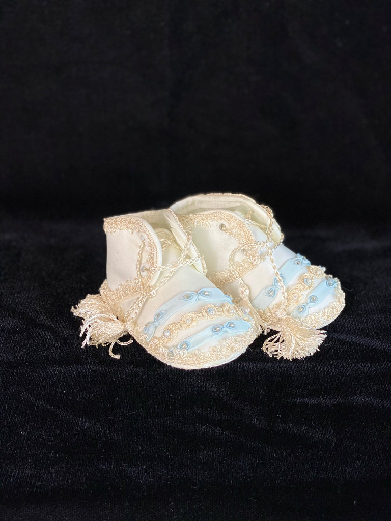 Elegant handmade English style ankle boots in ivory with blue ribbons, embroidery, jewels, and tassel like laces.