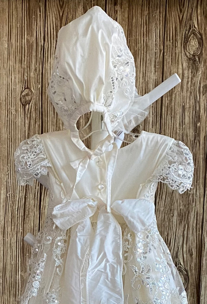 This a beautiful, one-of-a-kind baptism gown.  A lovely gown for a precious child.  Ivory, size 12M Satin bodice with embroidered sequins lace Embroidered sequins lace cap sleeve Embroidered sequins lace skirt overlay Matching bonnet