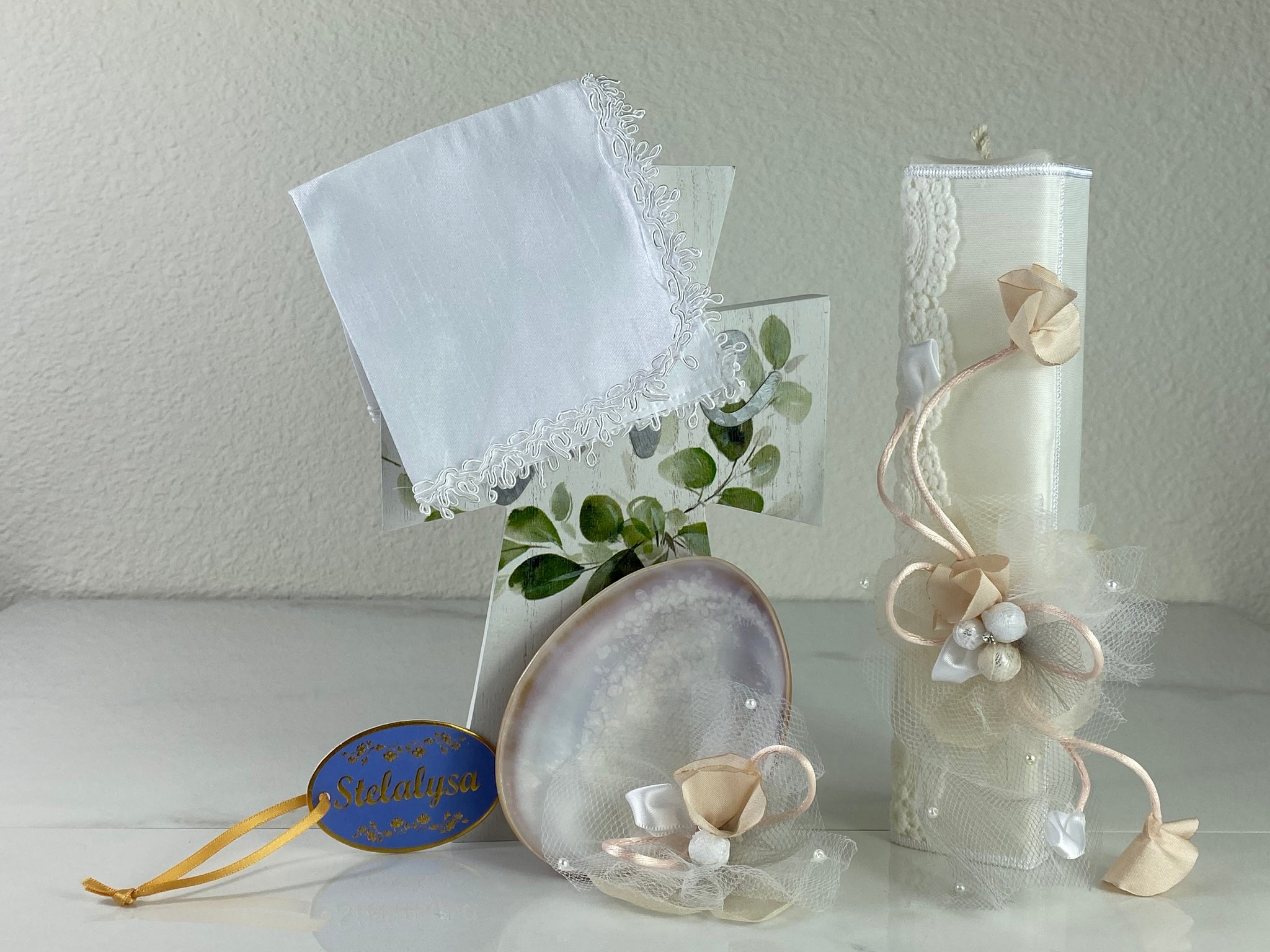These one-of-a-kind Candle set is handmade and ivory in color.  This candle has an elegant look.   It is uniquely decorated with crystals, lace, tulle, and ribbons making it a gorgeous keepsake.   This candle is rectangle in shape.    To match, the Shell is put together piece by piece to compliment the Candle and Handkerchief.  The Handkerchief is made of satin and embroidered lace to match the Shell and Candle beautifully.  