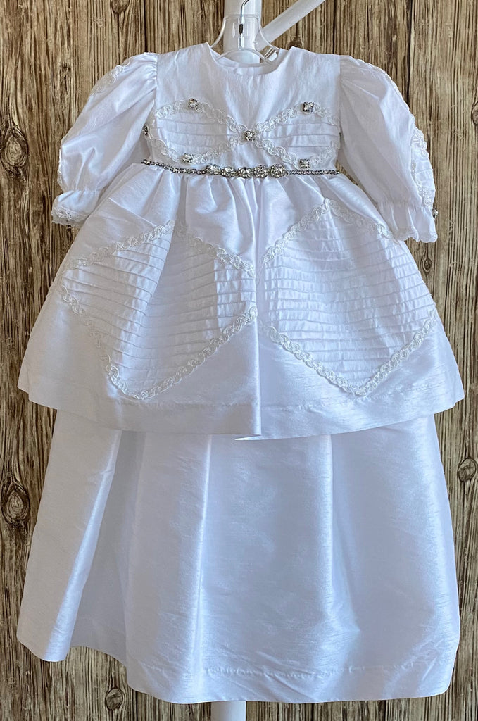 This a beautiful, one-of-a-kind baptism gown.  A lovely gown for a precious child.  White, size 6M Satin bodice Ribbon detailing along bodice and sleeves Rhinestones along bodice  Puffed sleeves Satin skirting with ribbon detailing 