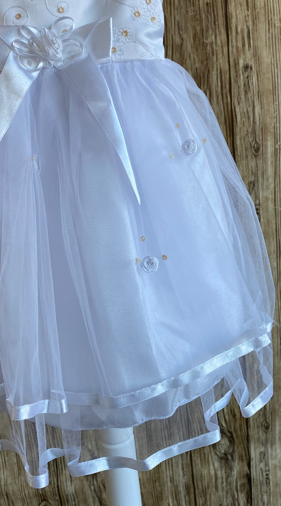 This a beautiful, one-of-a-kind baptism gown.  A lovely gown for a precious child.  White, size 12M Satin bodice with gold (sequins) and white embroidered flowers White cap sleeve  Large bow with floral center on bodice edge Tulle skirting with white roses Ribbon edge around tulle skirt Large ribbon bow in back 