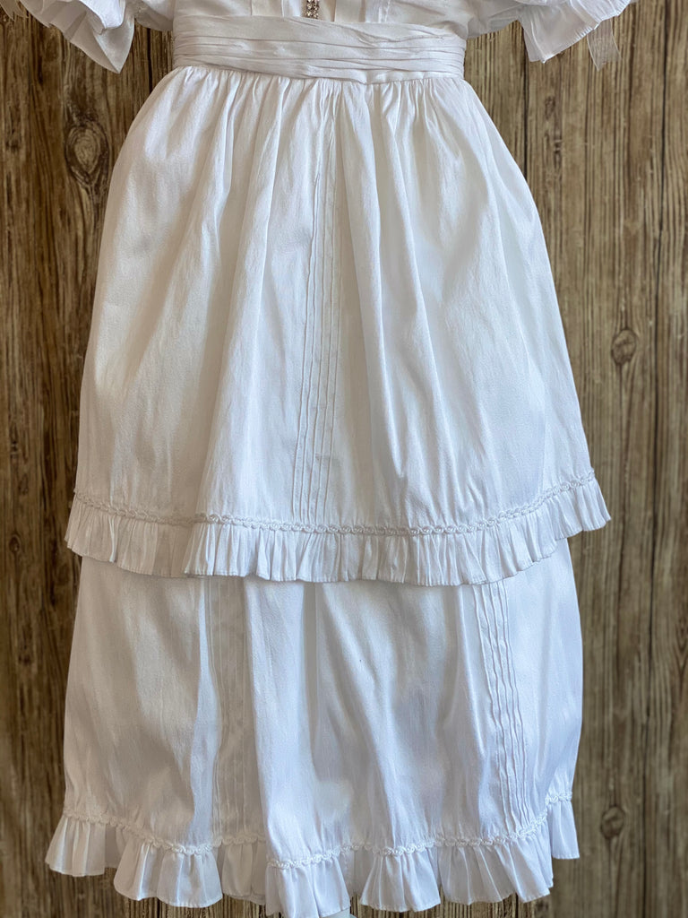 This a beautiful, one-of-a-kind baptism gown.  A lovely gown for a precious child.  White, size 24M Silk bodice with pleated belting effect Rhinestones throughout bodice Two piece silk skirting Pleated detailing on skirt  Pinstripes on skirting Ruffled trip along skirt edge Ruffled sleeves Button closure