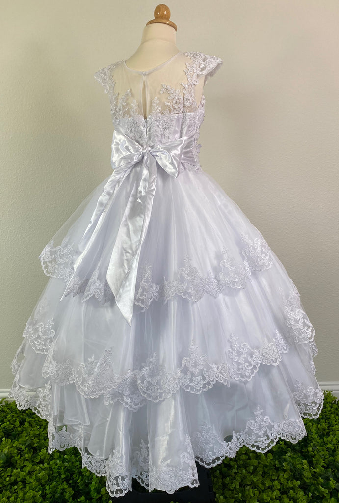 White, size 10 Satin trimmed cap sleeve with scoop neck Floral and lace illusion bodice with pearls and crystals Three-tiered embroidered lace trimmed skirt over satin underlay Zipper closure Satin ribbon for bow
