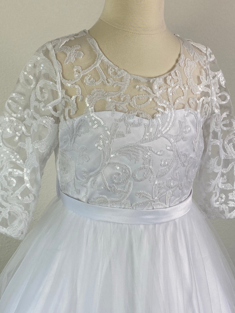White, size 10 Laced illusion bodice with scoop neck with sequins Lace quarter sleeve Thin satin belt band Satin skirt with tulle overlay and lace edging  Elegant short train showcasing the lace edging Zipper closure Elegant big bow detail