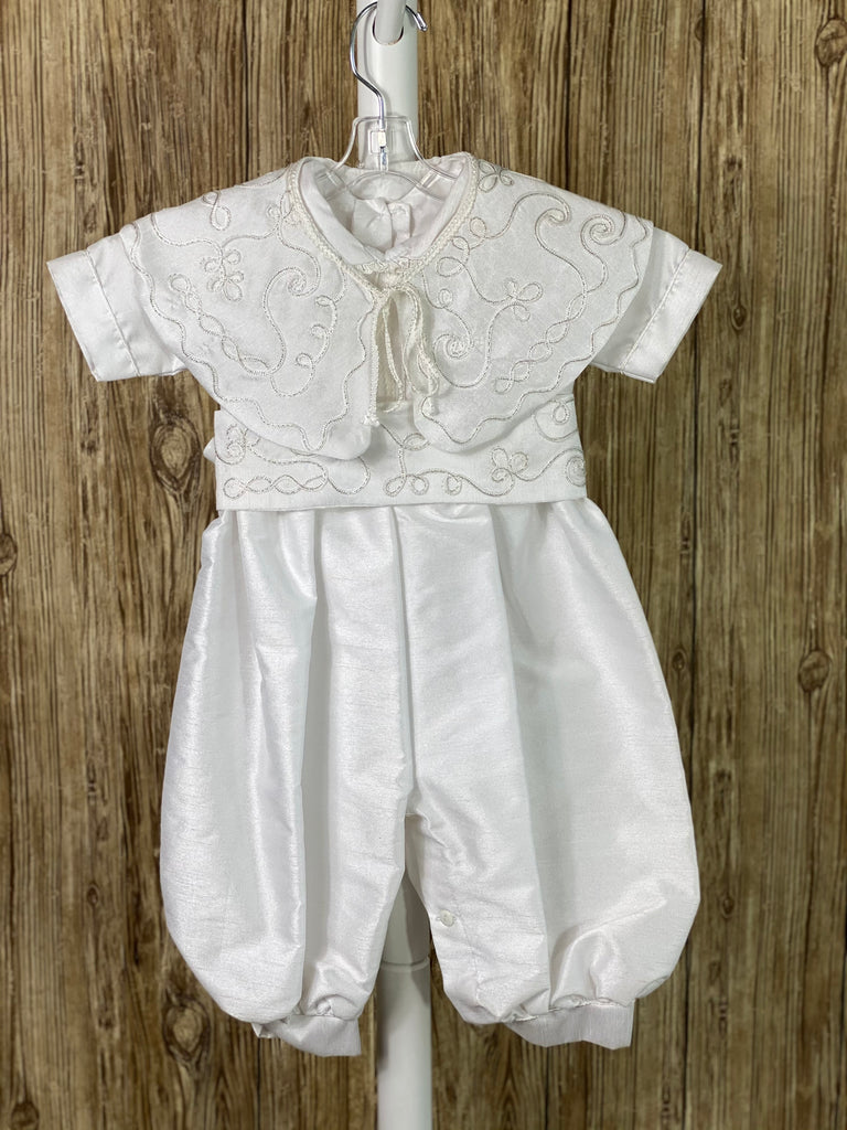 This a beautiful, one-of-a-kind boy’s baptism gown/set.  Lovely clothes for a precious child.  White, size 12M 4-piece set including beret, romper, belt, and mozzetta Buttoning on cuffs Collared with short sleeves Buttoning on back of romper and inside seam of legs Simple satin romper with very thin trim along cuffs and down center of bodice Braided trim swirled around belt and mozzetta Braided rope closure on mozzetta