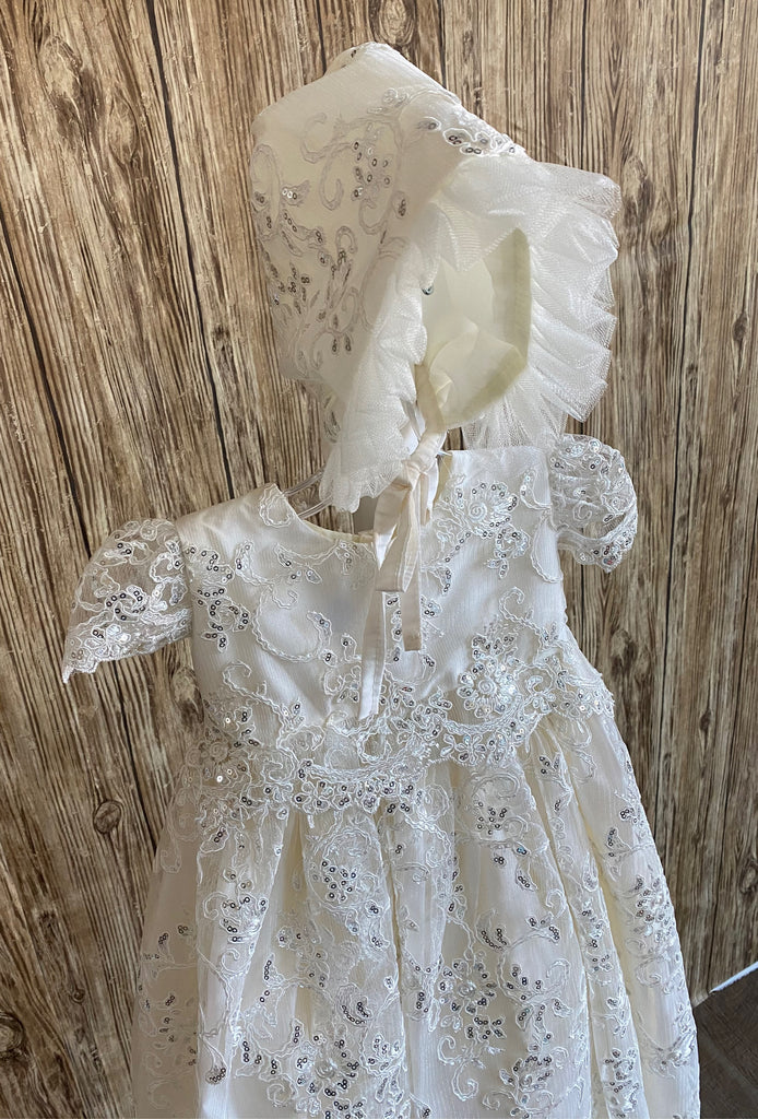 his a beautiful, one-of-a-kind baptism gown.  A lovely gown for a precious child.  Ivory, size 6M  Satin bodice with sequins embroidered lace overlay Sequins embroidered lace cap sleeve Pleated sequins embroidered lace skirting Satin bonnet with sequins embroidered lace overlay Tulle ruffled brim on bonnet