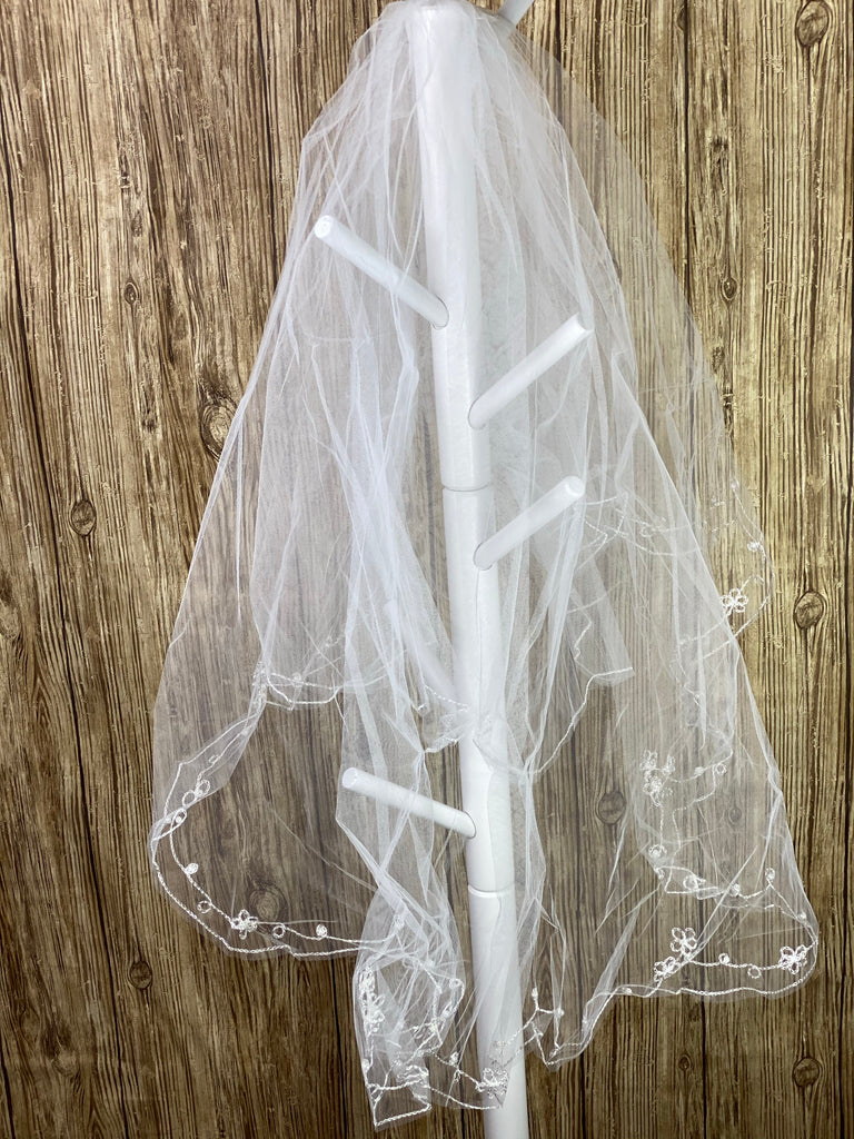 White - Flower Pearl Veil for First Communion   Elegant soft 2 layer veil with delicate white hand stitched flowers with pearls.  Veil length - 34 in. long, comb - 7 cm wide  Materials:  sturdy plastic comb, soft tulle, and applique - pearls.