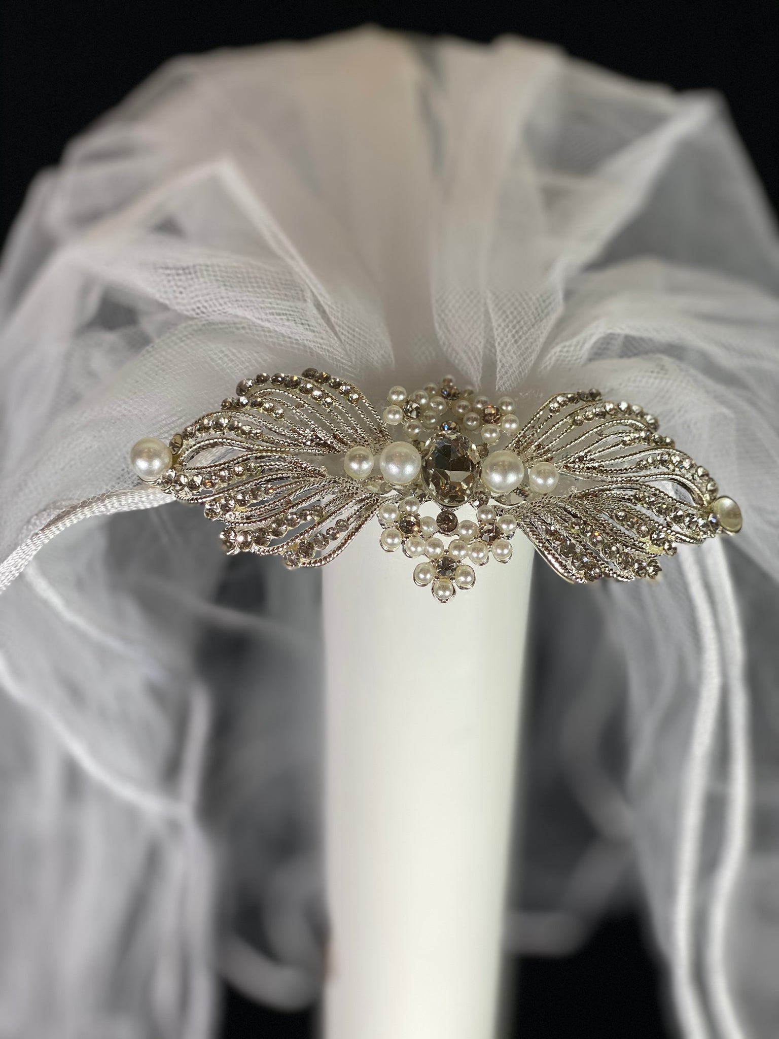 Veil - White Elegant First Communion Veil on Decorative Comb  Elegant soft 2 layer tulle veil with delicate hand stitched braided satin trim around the edge and handmade decorative comb with pearl and rhinestone detailing.  This double layered veil reaches approximately 21" long. Veil has 1.5" long, 2" wide, metal comb to secure it in place. 