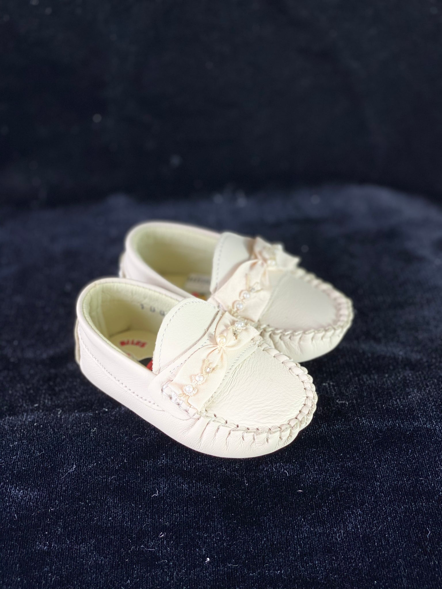 Soft pleather ivory loafers with bow and pearls.
