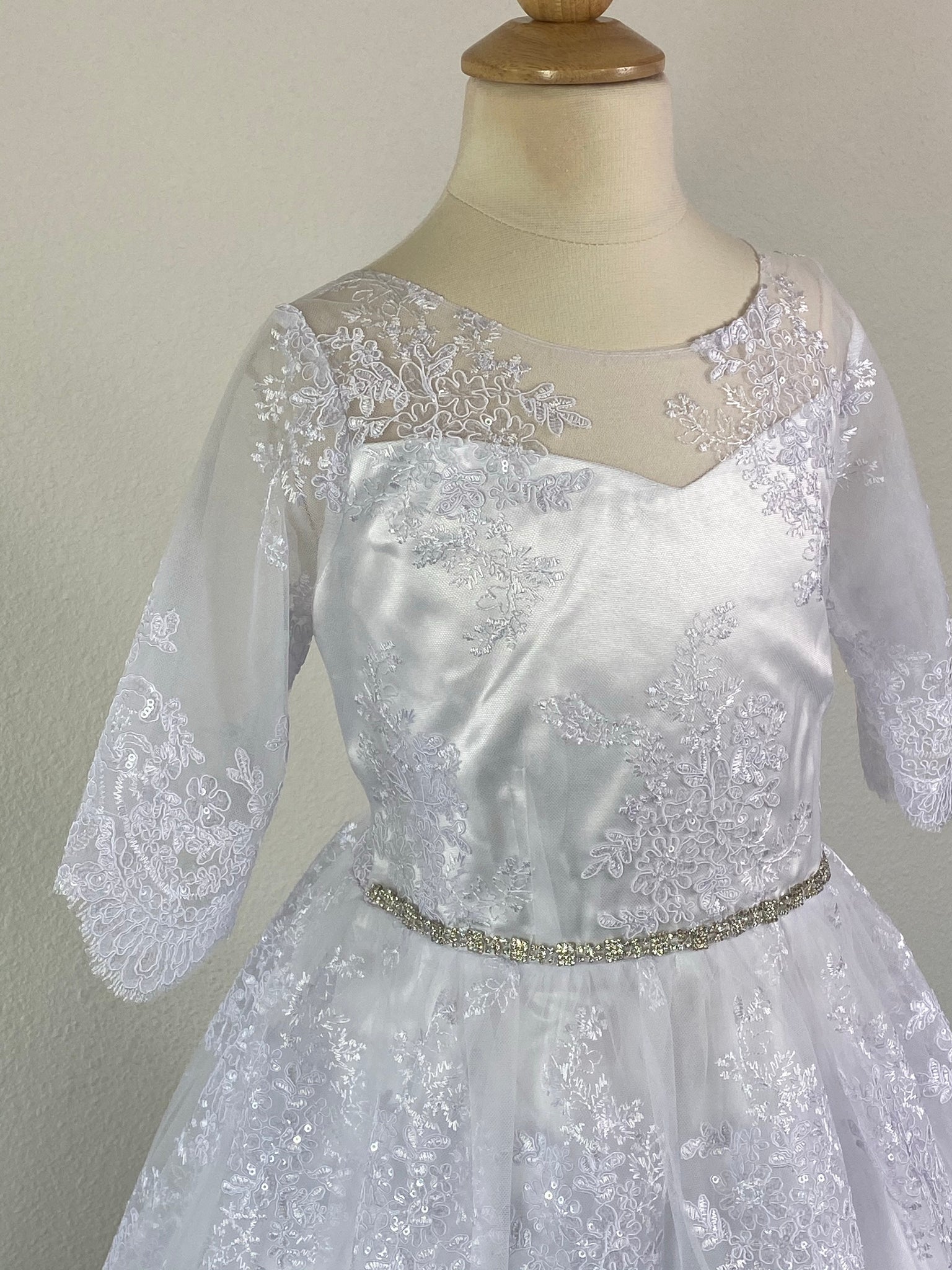 Quarter Bell Sleeve with Lace Overlay Embroidered illusion Bodice Elegant thin rhinestone belt Floral sequined Lace Overlay on Skirt Zipper closure Embroidered sequins ribbon for bow