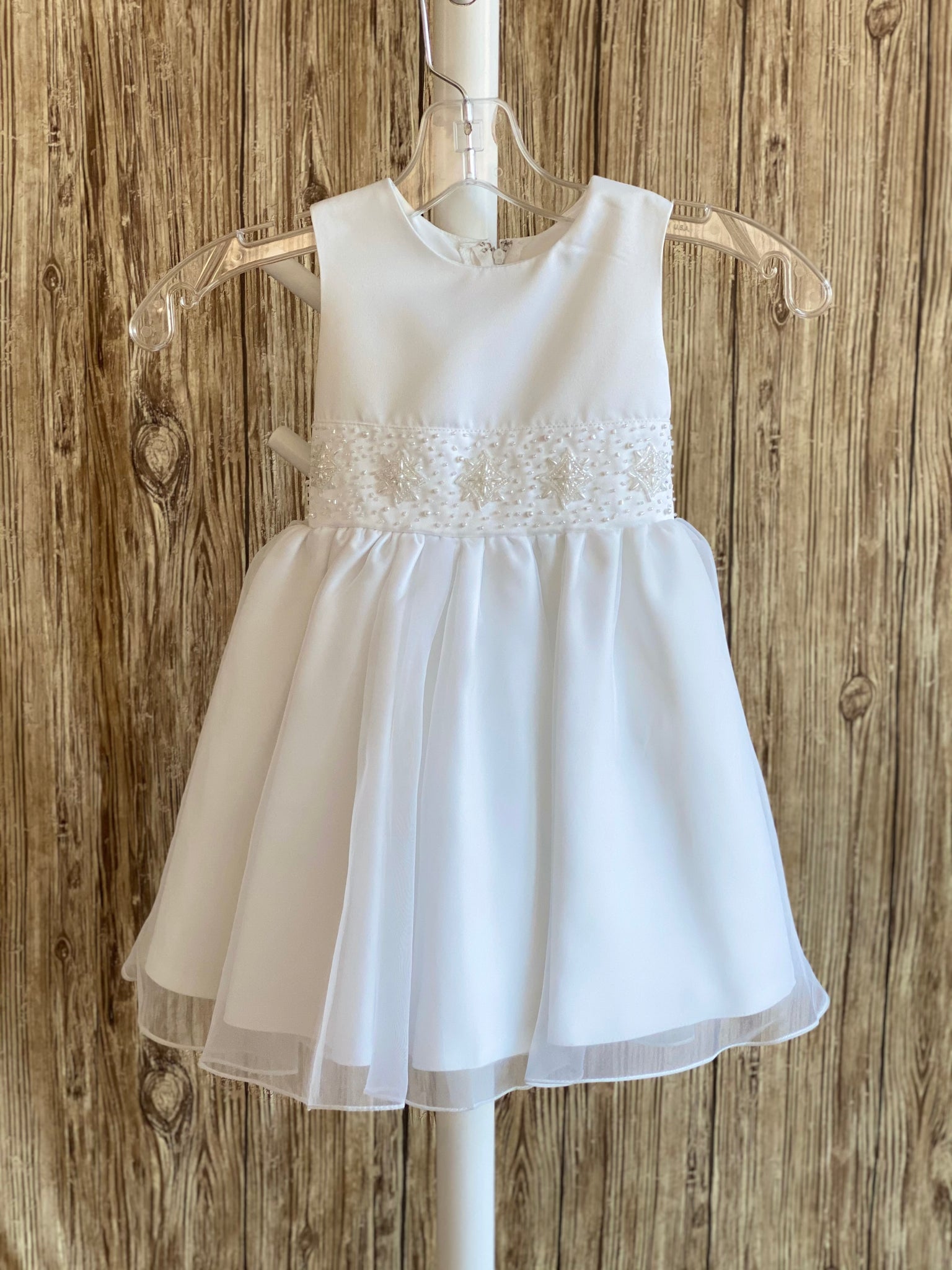 This a beautiful, one-of-a-kind baptism gown.  A lovely gown for a precious child.  White, size 24M Satin bodice with short sleeve beaded detailing along bottom Satin skirting with mesh overlay Zipper closure