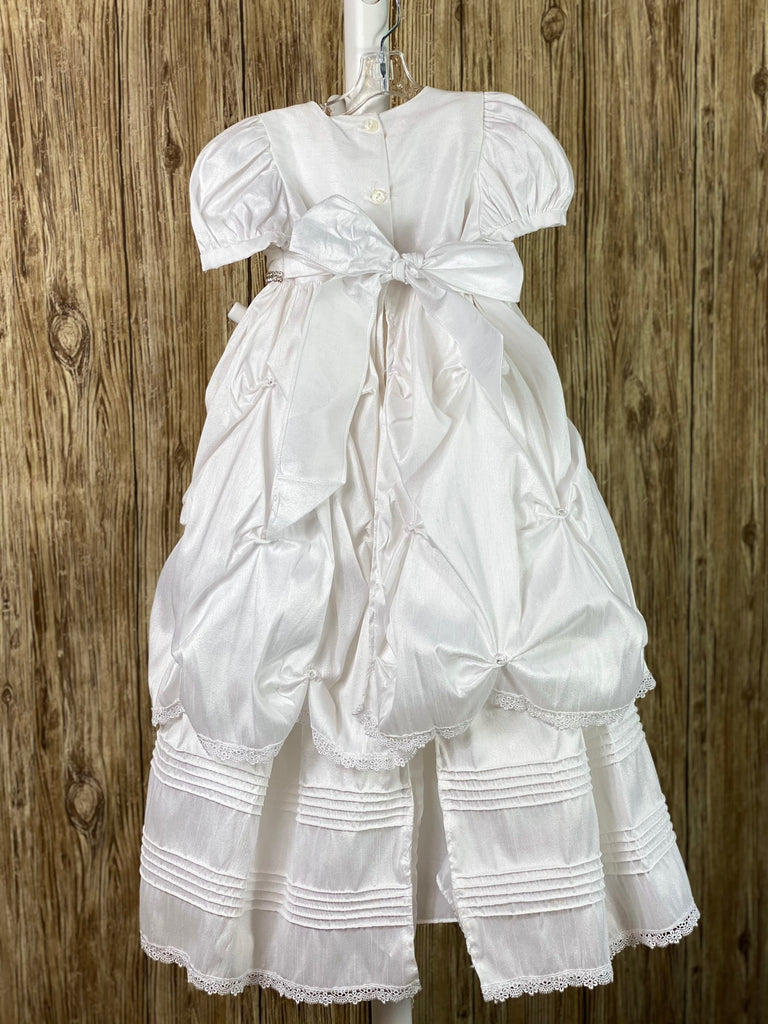 This a beautiful, one-of-a-kind baptism gown.  A lovely gown for a precious child.  White, size 24M Two layer dress Satin bodice  Rhinestone belting Puffed satin sleeves Gathered ruffled skirting with rhinestones Second layer has horizonal pinstripes with lace trim  Satin bow in back