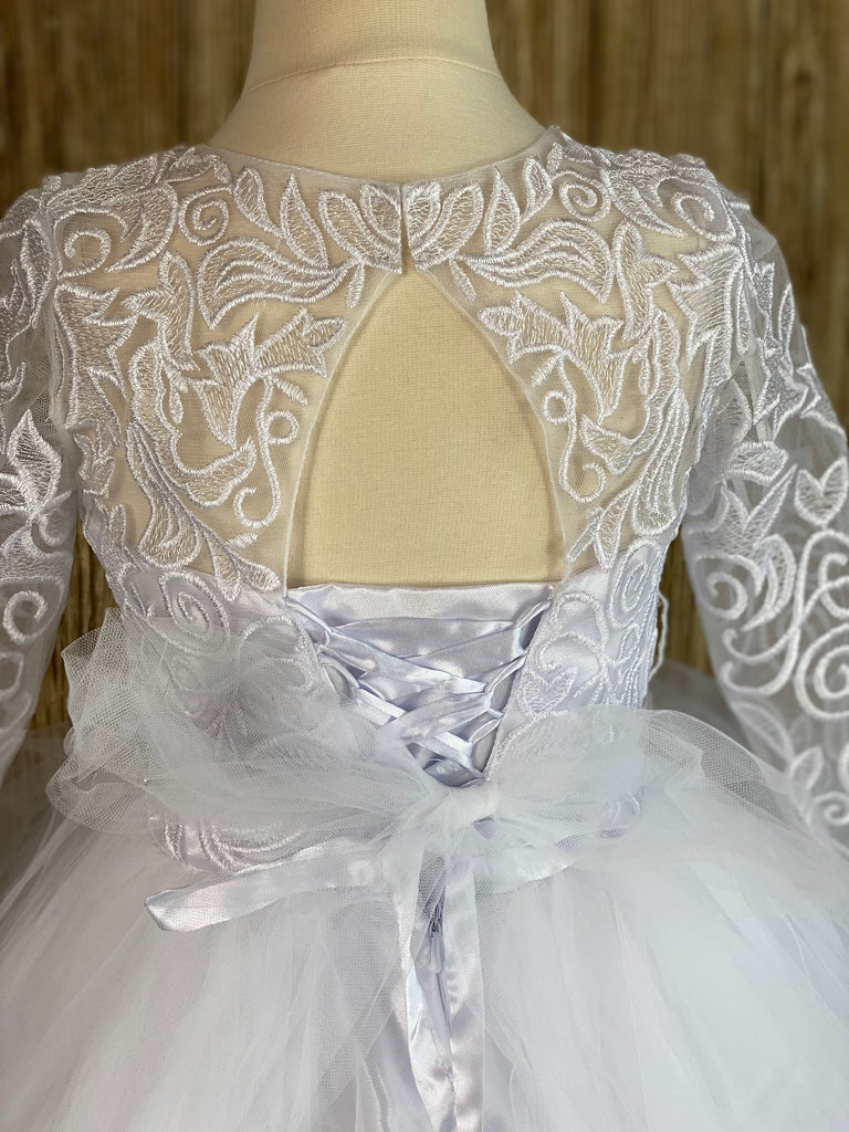 Embroidered Lace over white satin bodice Long sleeve Pearl and Rhinestone belt Layered tulle skirting with satin ribbon edge Key hole back Corset style closure