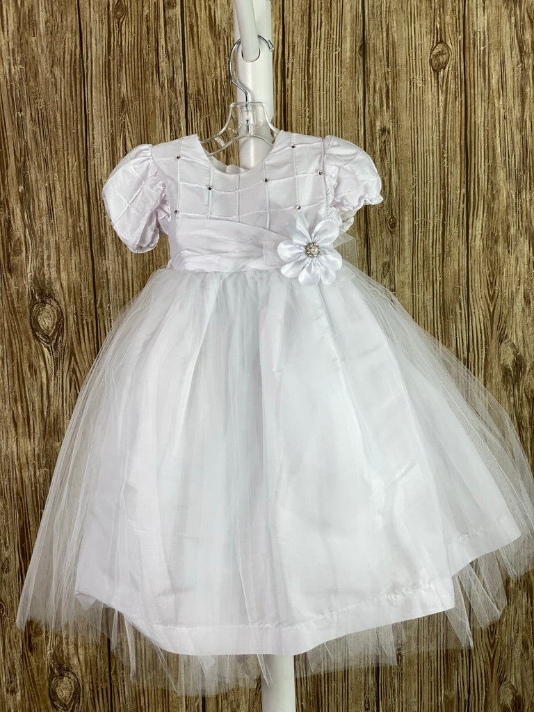 This a beautiful, one-of-a-kind baptism gown.  A lovely gown for a precious child.  White, size 12M Cubed satin bodice with rhinestones Satin cubed sleeves Satin belt with flower Tulle skirting with satin underlay Satin bow in back Button closure